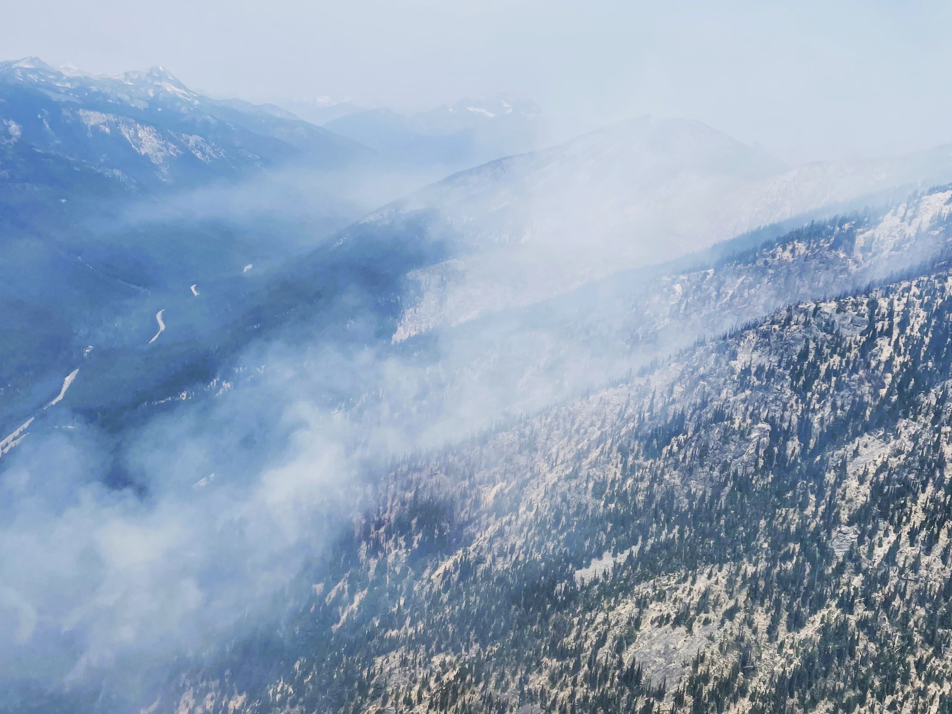 

						Photo: Smoke rises above the Easy Fire on July 18, 2024 in the Methow Valley in north central Washington. Source: USFS 
			