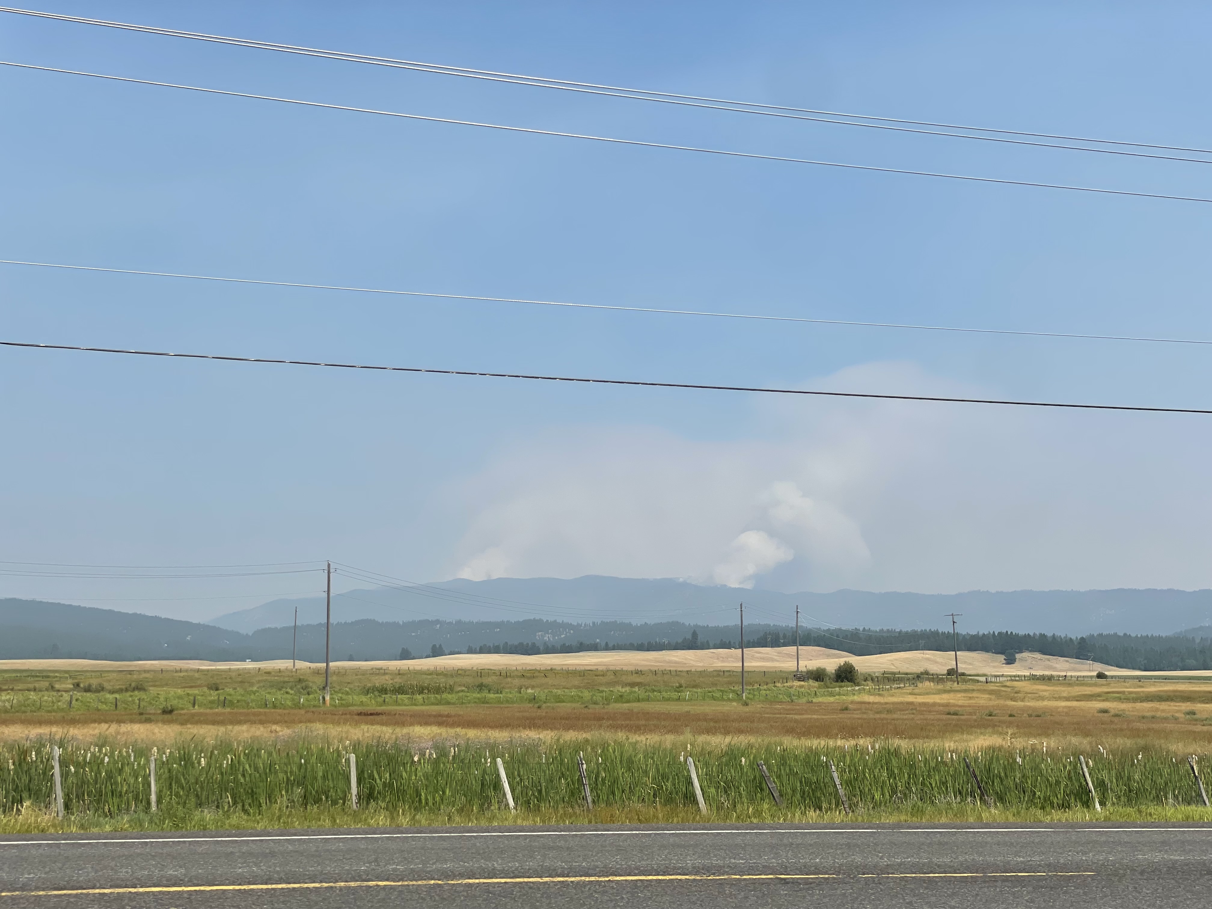 

						Two smoke columns rising up behind the ridge
			