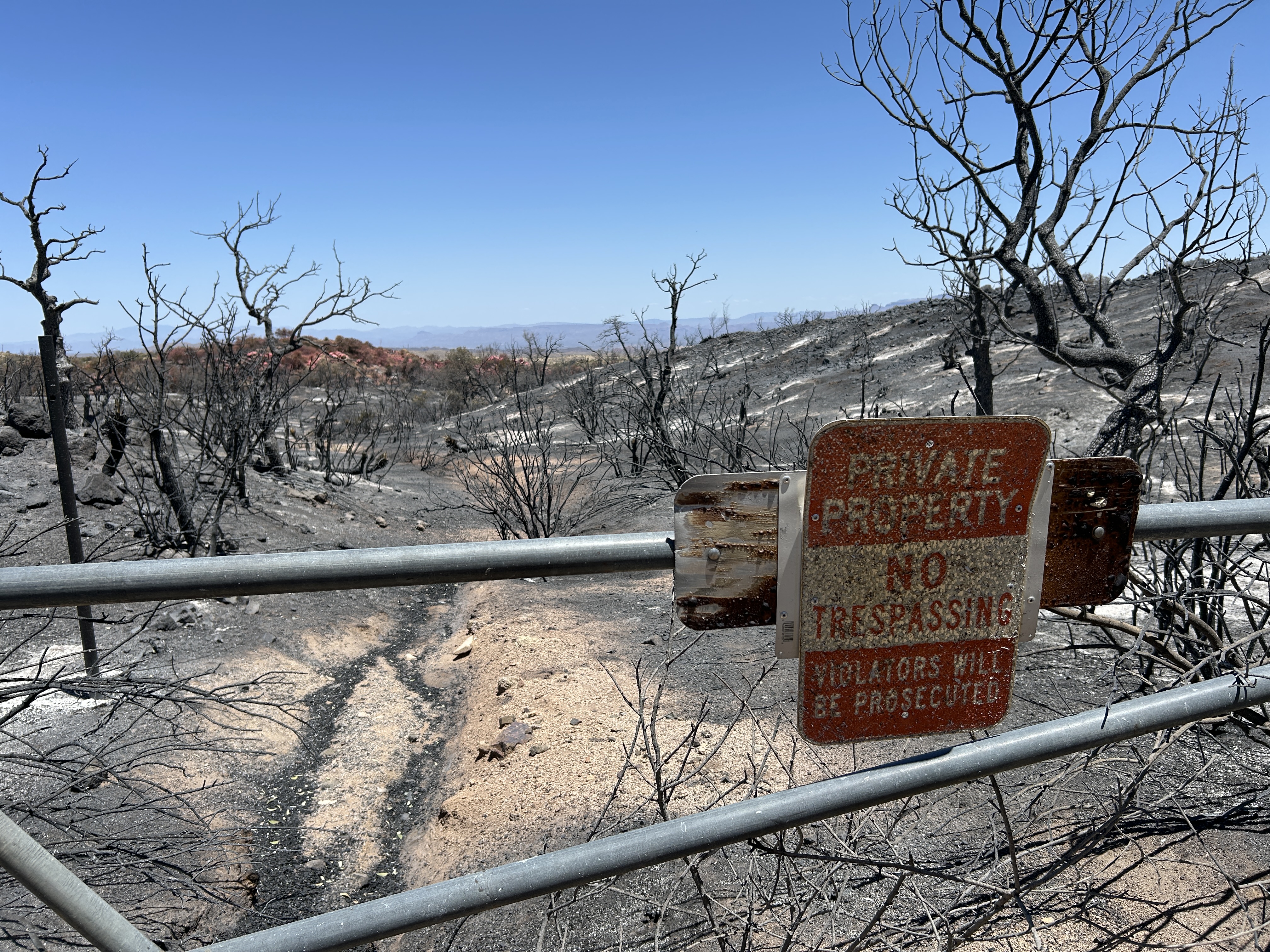 

						Gate with burned private property sign.
			