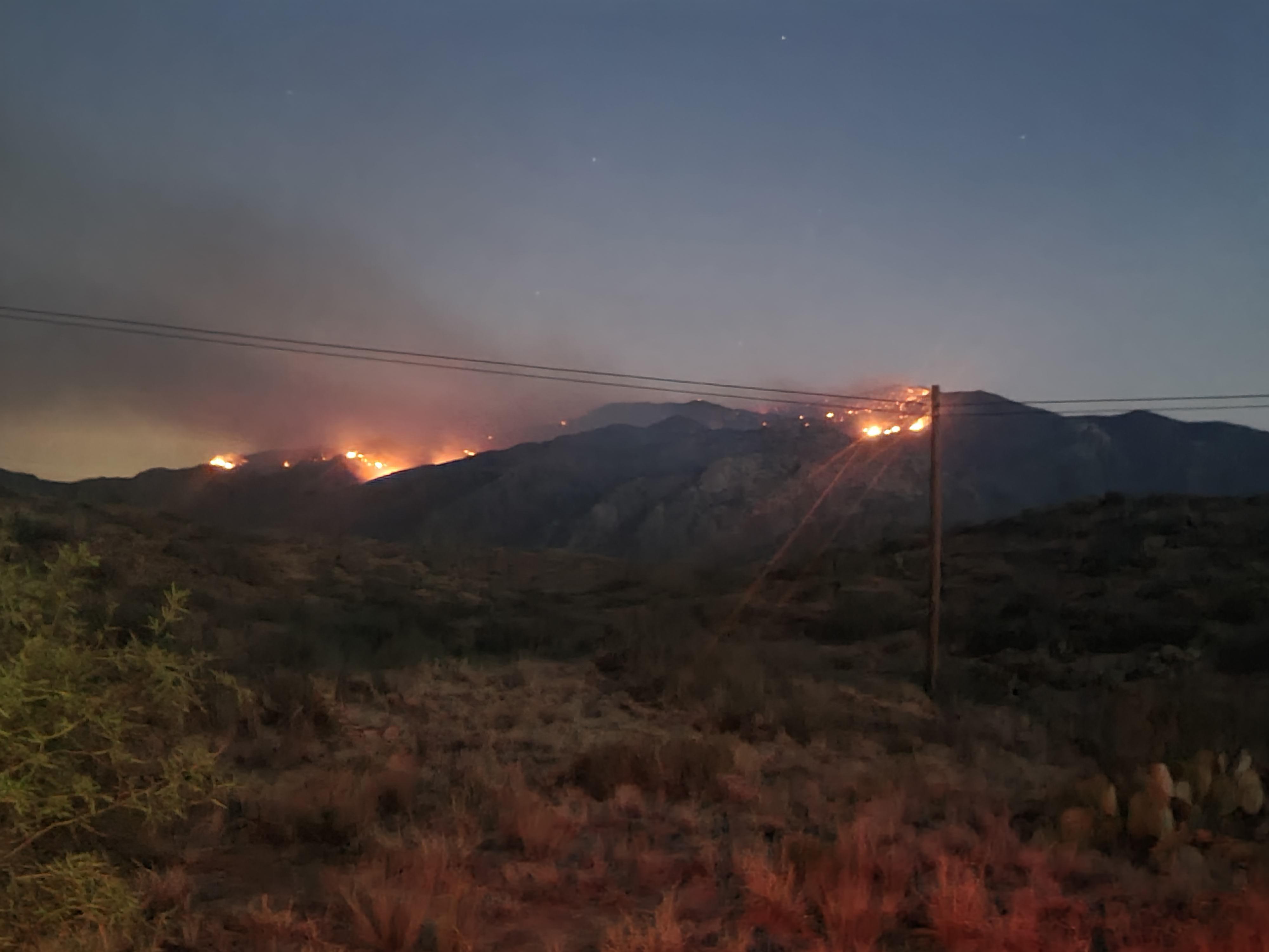 Night time July 7 Fire visible in night sky on top of mountain