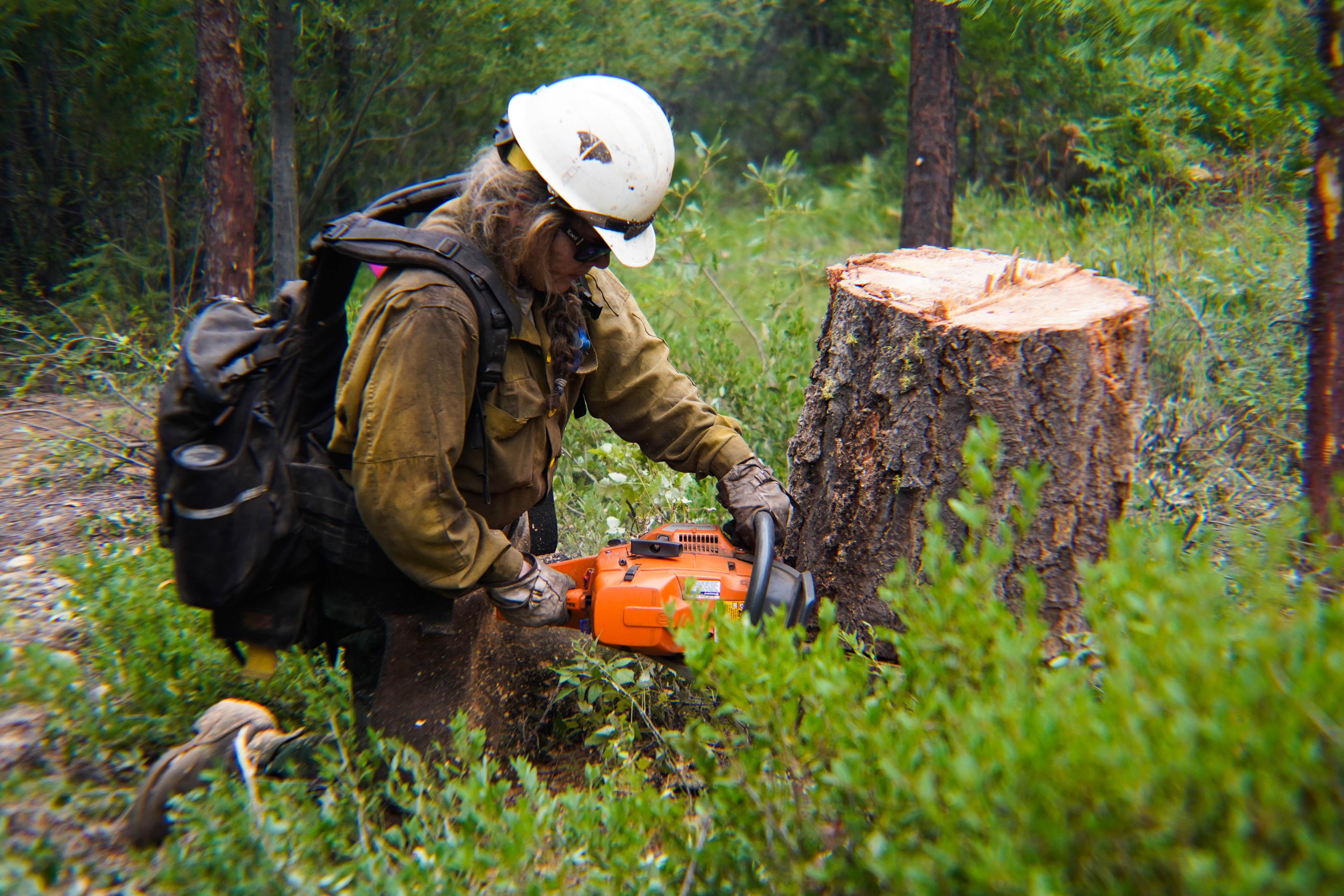 Angela Lockwood, with Firestorm Wildland Fire Suppression, Inc, works providing structure defense for residents of Coffee Creek, Aug 15, 2021, on the River Complex Fire. (U.S. Forest Service photo courtesy of Benjamin Cossel)