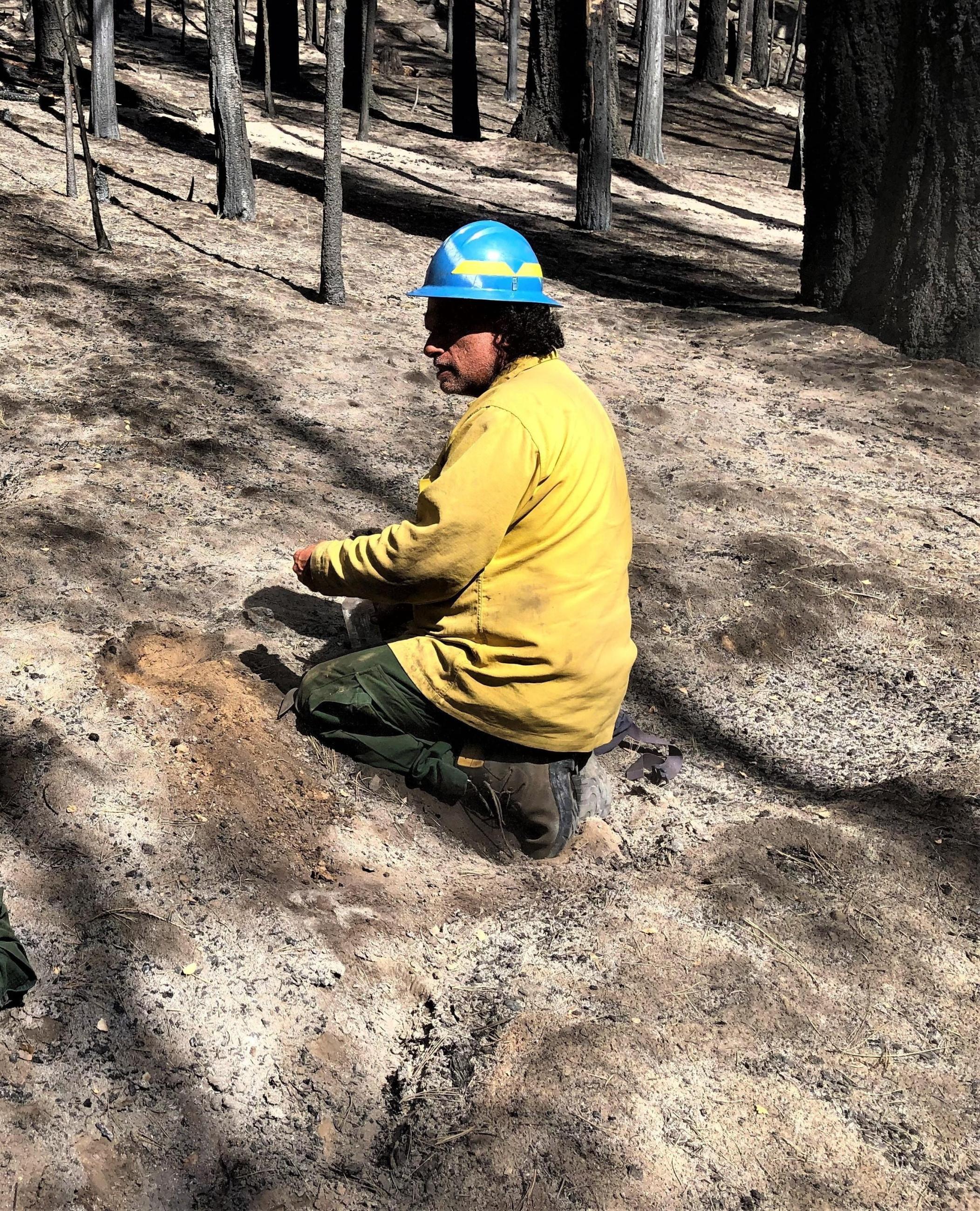 BAER Soil Scientist Eric Nicita evaluating soil Photo showing BAER Soil Scientist Eric Nicita evaluating water repellency of burned soil in Caldor Fire
