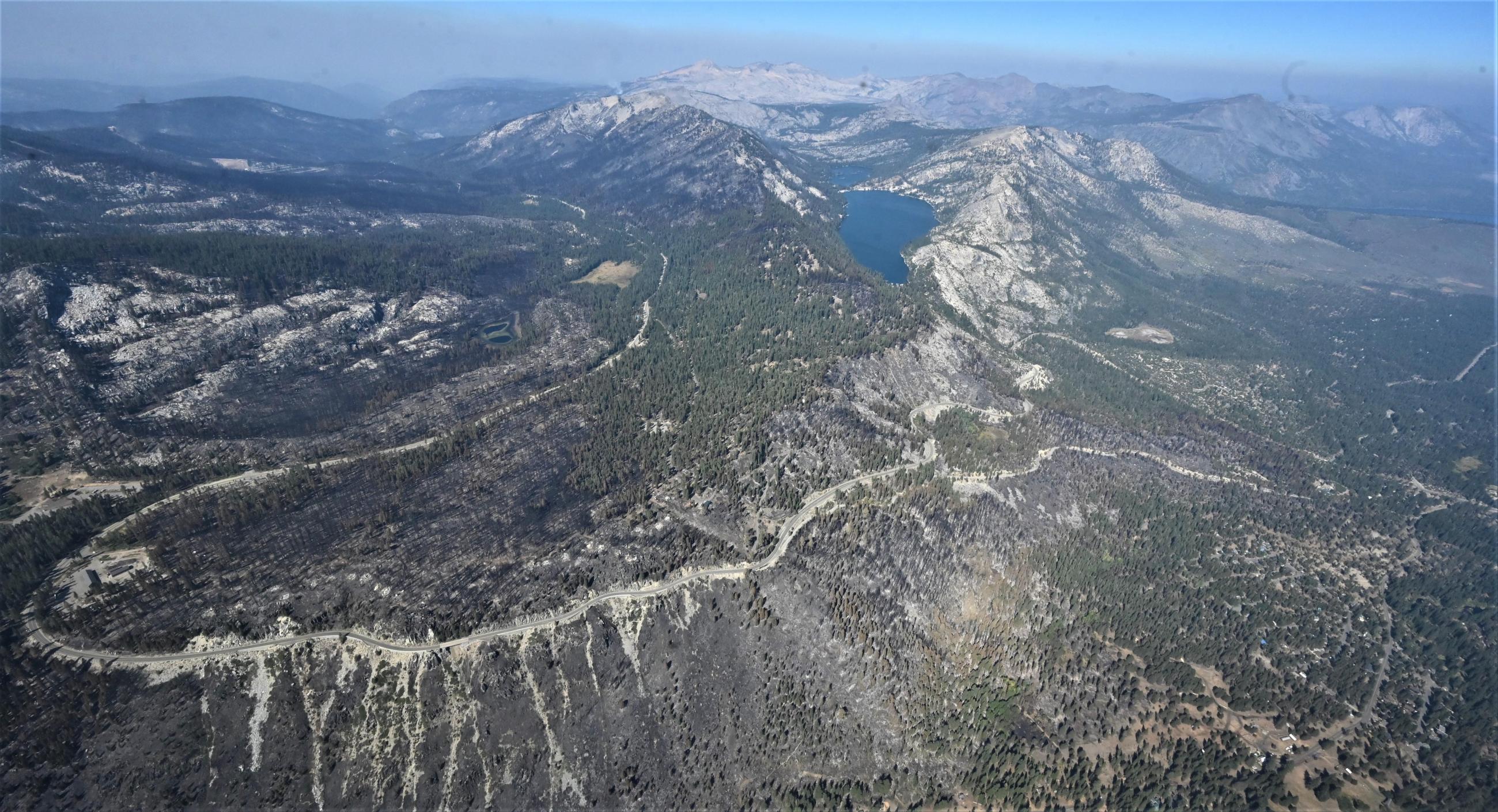 Aerial view of Hwy50 within Caldor Fire Photo showing Aerial view of Caldor Fire Along Hwy 50 & Road Cut at Echo Summit