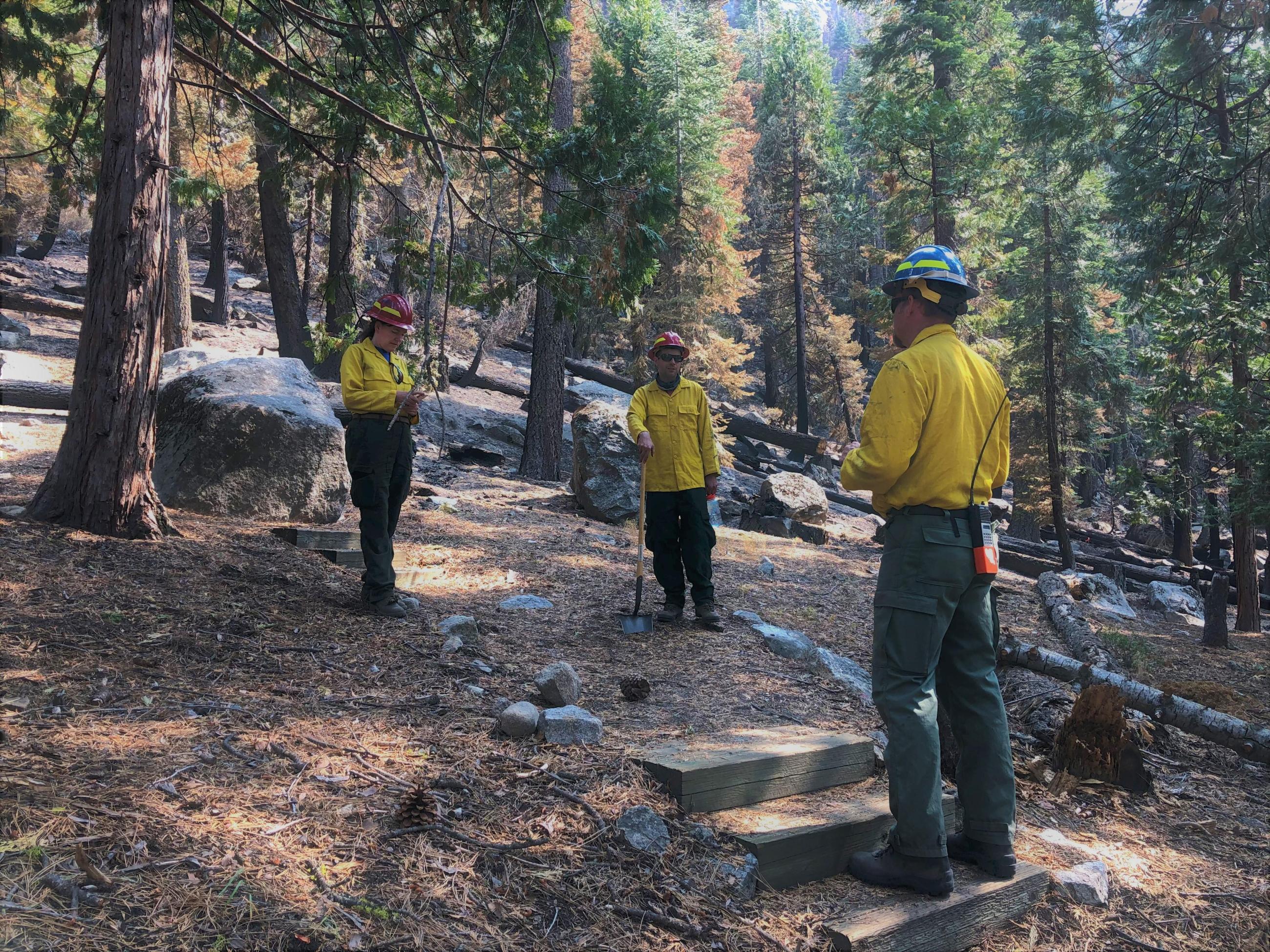 BAER Specialists assess potential rock fall hazard Photo showing BAER Hydro-Geologist Rebecca Biglow, Geologist David Annis, Recreation Officer Karl Goodwin at Lovers Leap CG discussing potential rock fall hazards & safety of campers