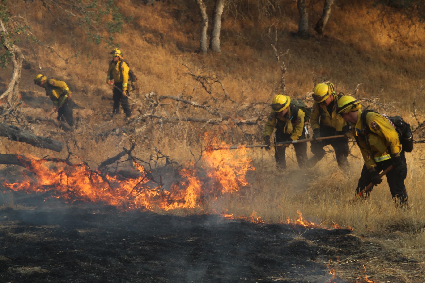 Firefighters construct handline to stop the fire's spread on the southwest flank near Deer Creek Road.