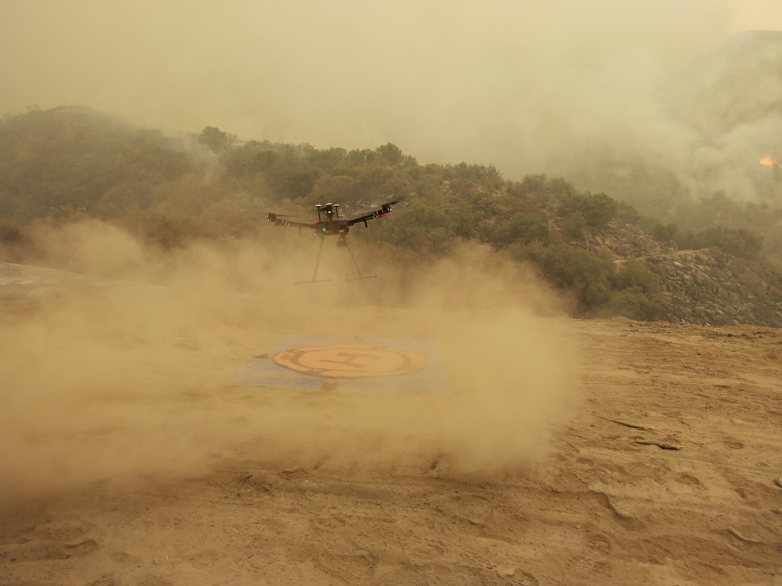 Drone taking off for a mission over a landing pad into a valley with active fire to determine fire edge using infrared photography. Photographer Laid Naylor, US Forest Service