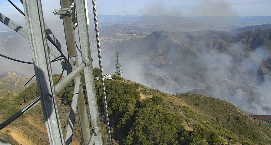 Light smoke rising from burned hillside, after fire had laid down.  Photo taken form a communications tower.