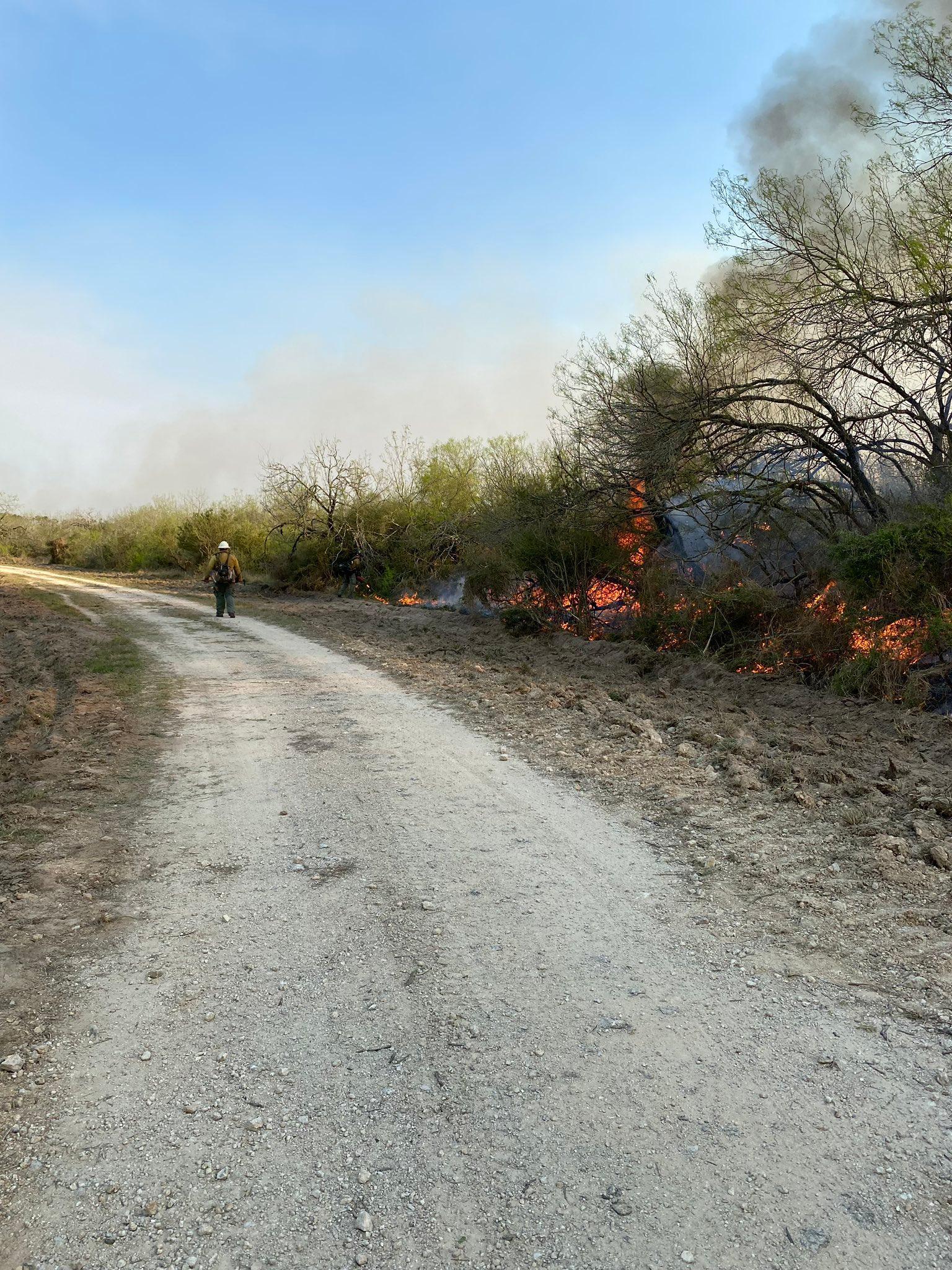 Firefighter patrols the Hayfield South Fire in Kenedy County on March 26, 2022.