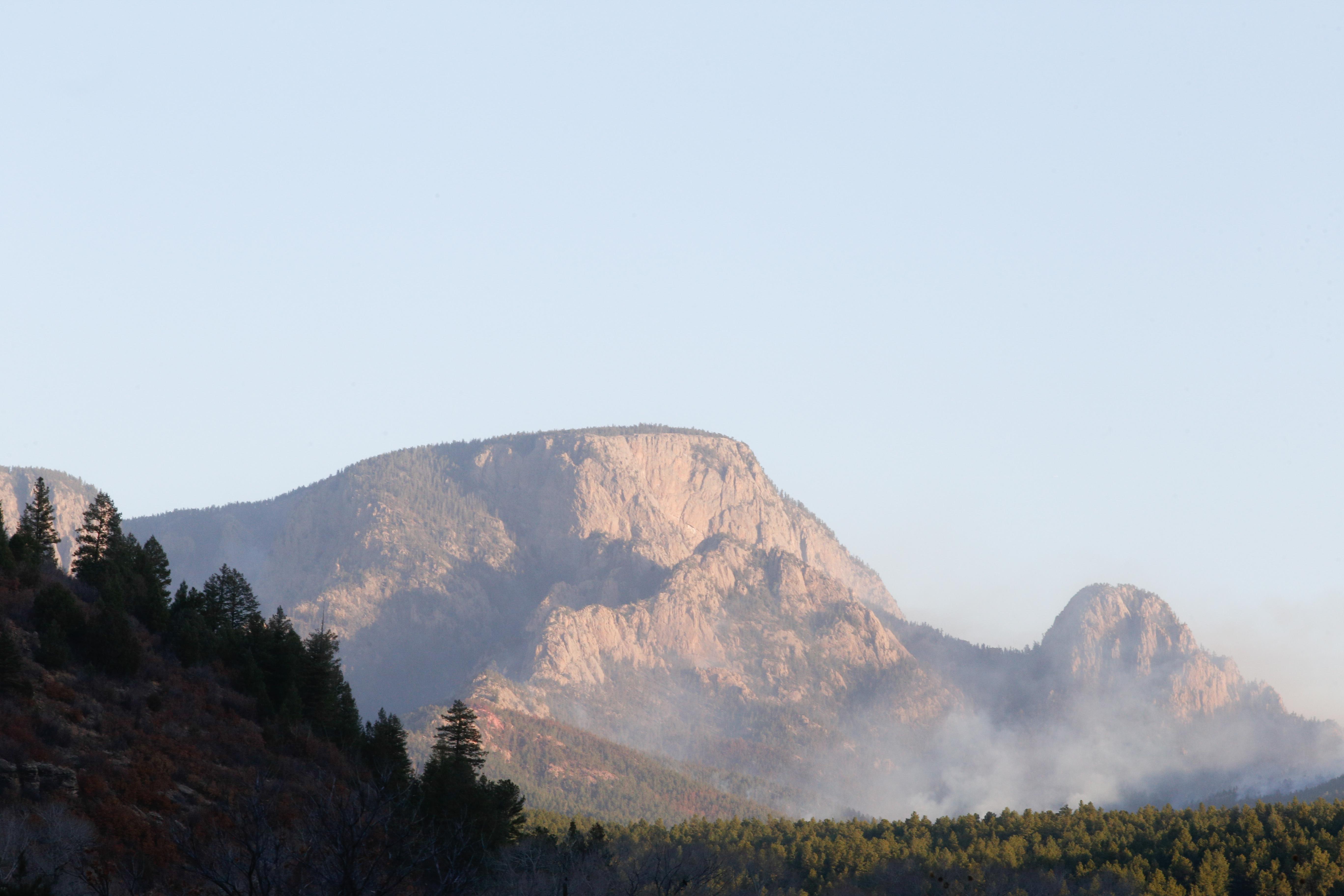 Smoke at the base of Hermit Peak on the morning of April 11. (USDA Forest Service photo by Andrew Avitt)