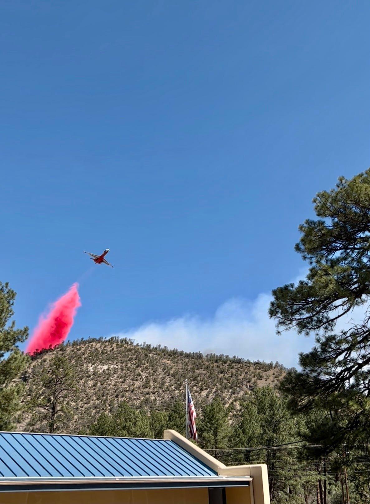 A large airtanker drops retardant on the McBride Fire above Ruidoso, NM, April 14, 2022