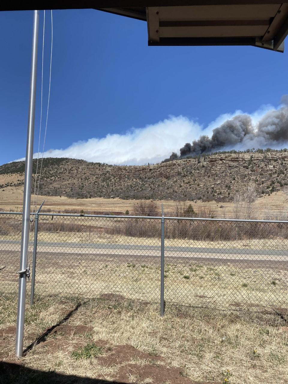 Image of smoke from the Cooks Peak Fire rising from behind a ridge