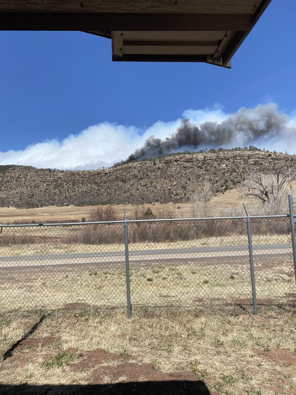Image of smoke from the Cooks Peak Fire rising from behind a ridge