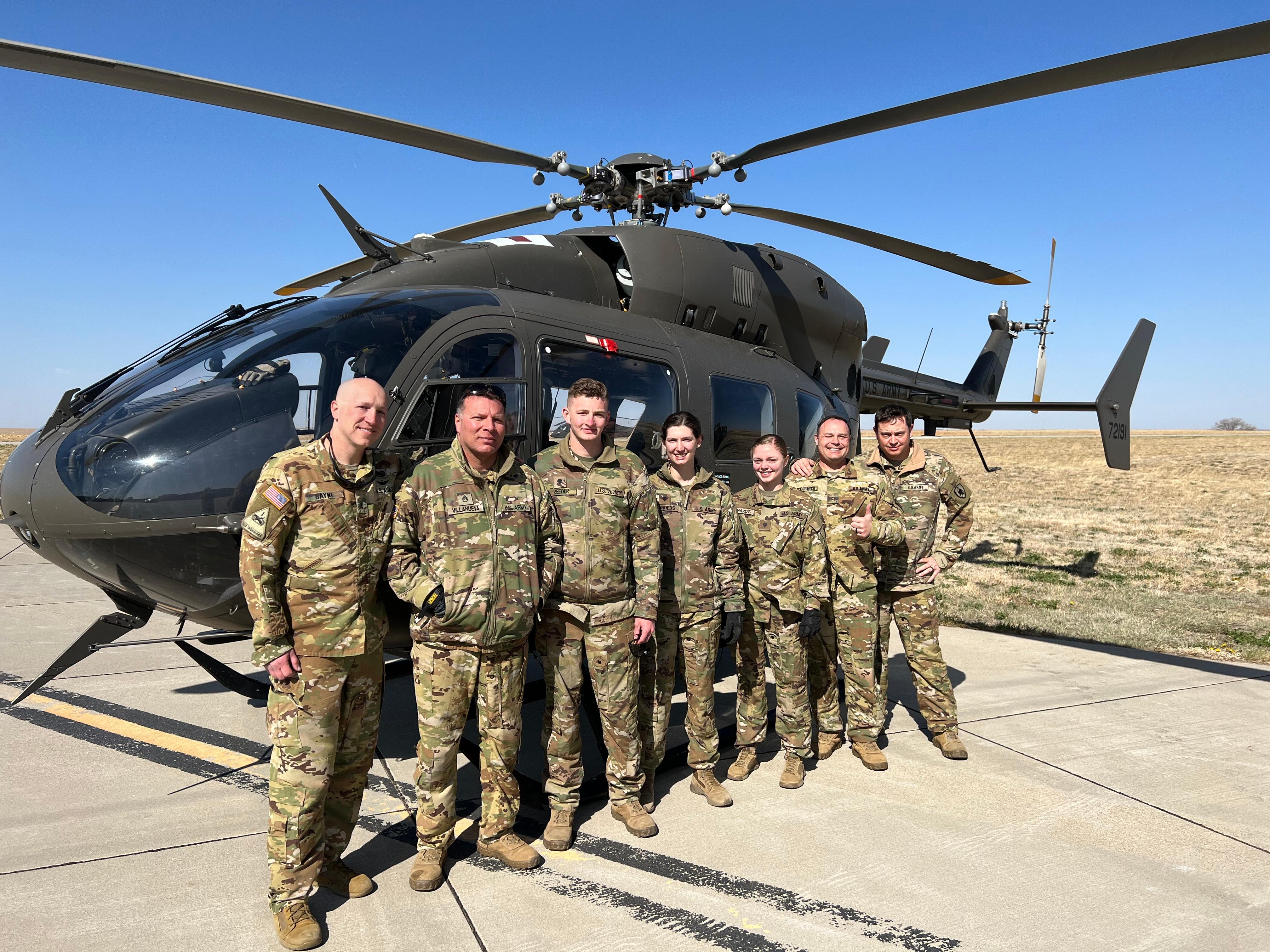 Soldiers of D Co, 1-376th Aviation Battalion out of Grand Island gather for a photo today in McCook where they have been supporting wildfire response the past four days. Pictured in front of the UH-72 Lakota helicopter (L-R): Chief Warrant Officer 3 Chad