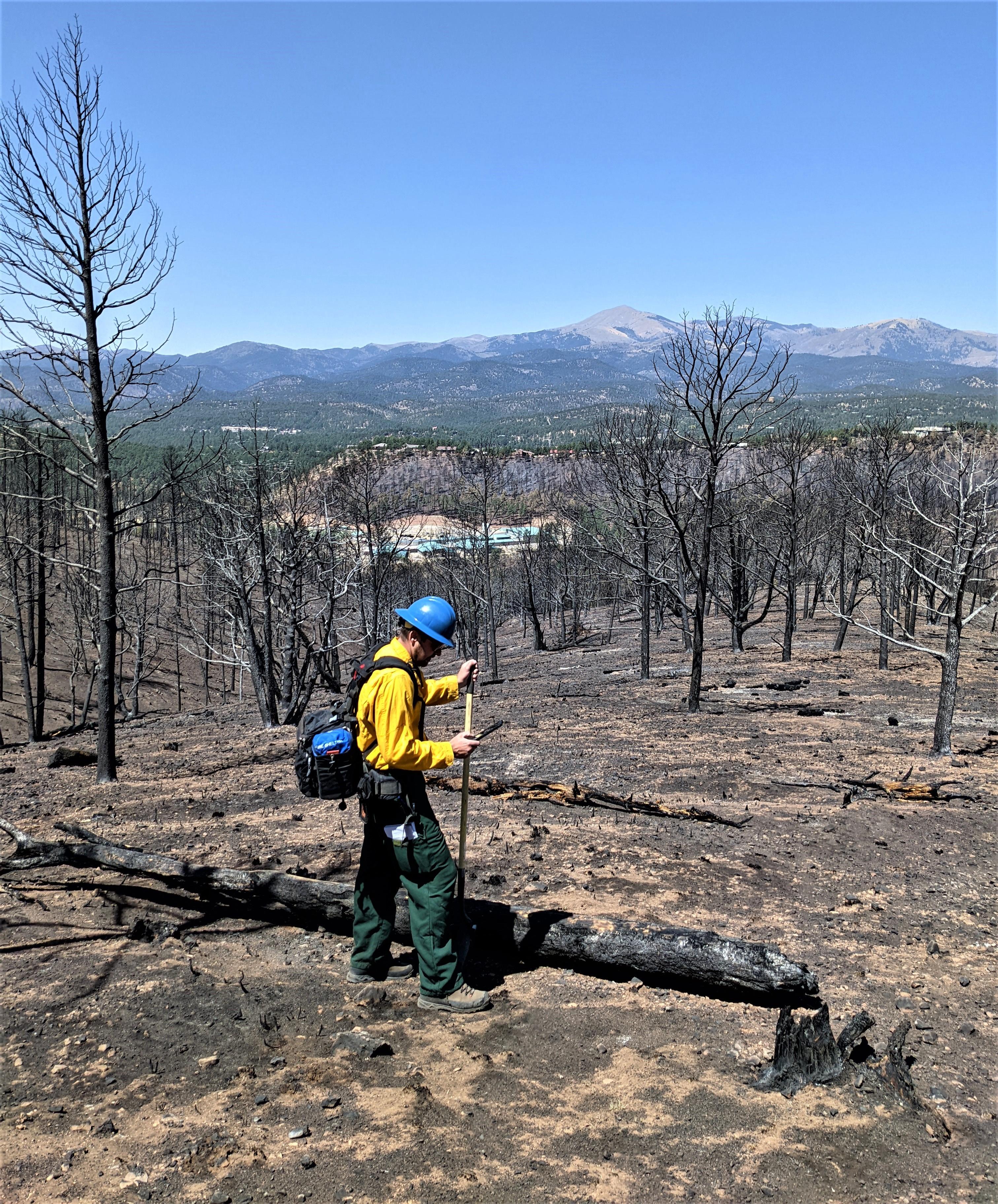 Image showing Forest Service BAER Soil Scientist Kyle Paffett recording soil burn severity conditions in McBride burned area