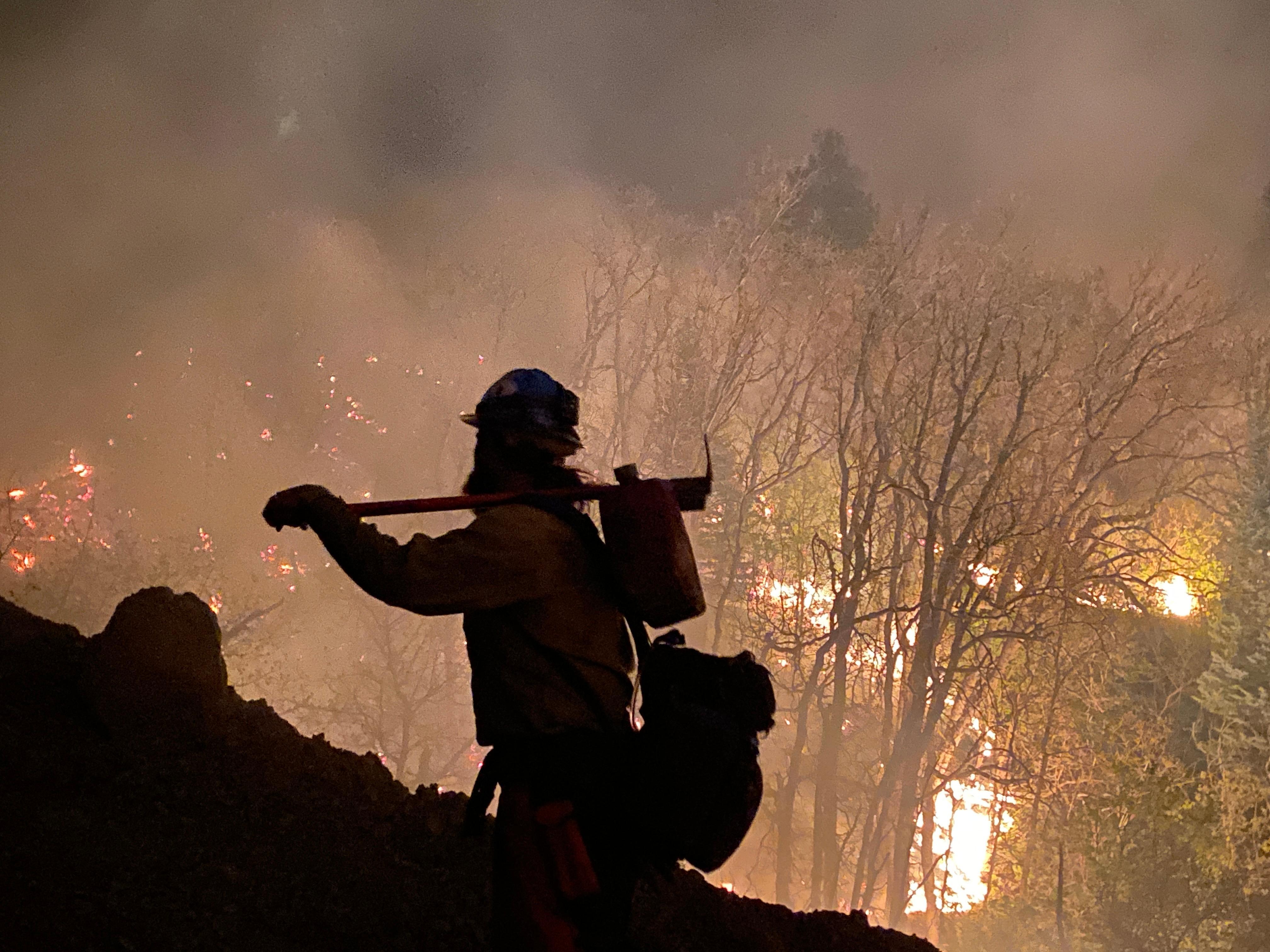 Firefighter watching for any embers across the line during a tactical firing operation at night on 4/26/22 Photo Credit: Angela Goldman, CAIMT4 PIO