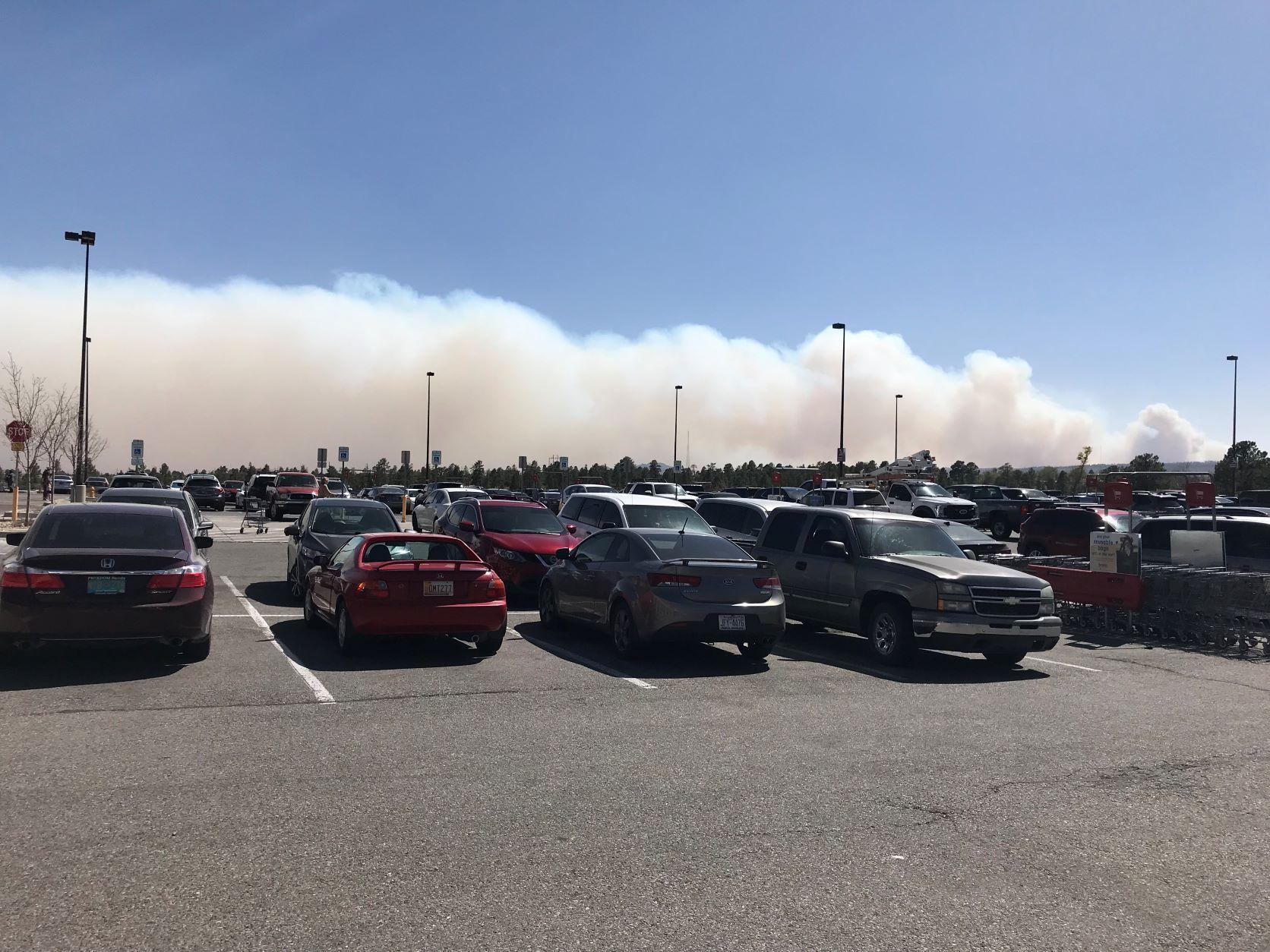 Looking across a parking lot at smoke from the fire