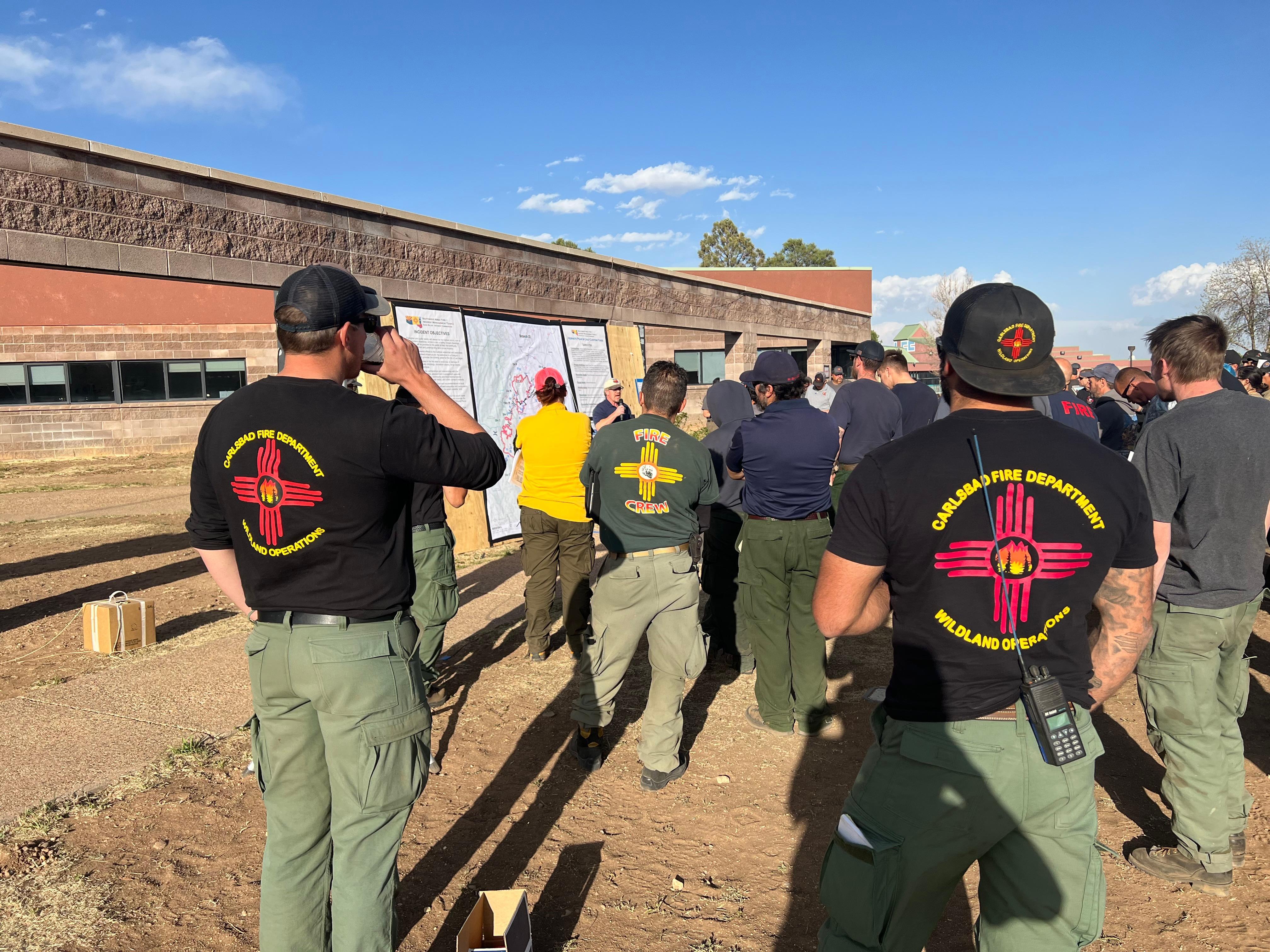 Firefighters during an operational briefing at Luna Community College during the Hermits Peak and Calf Canyon Fires.