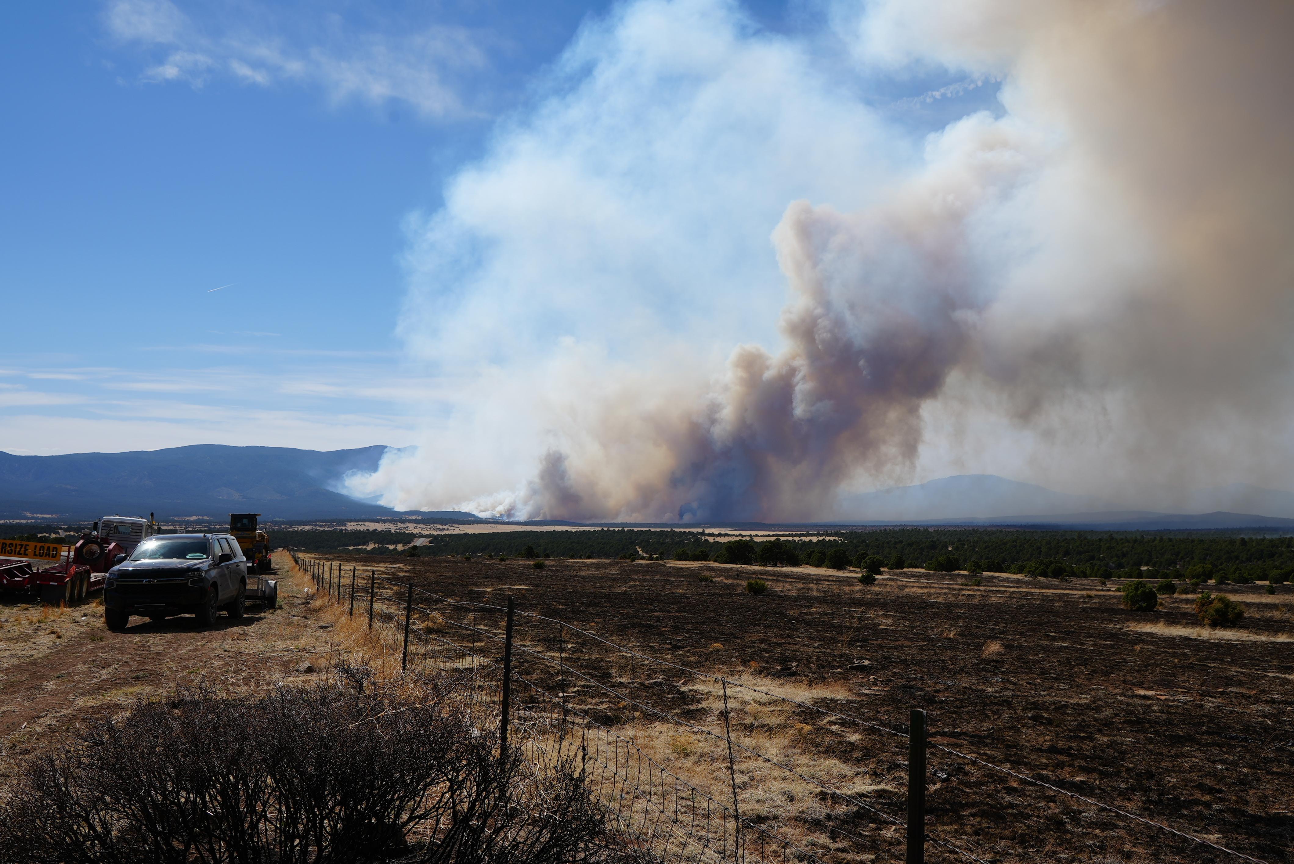 Fire activity as seen from along the southeast edge of the Hermits Peak and Calf Canyon Fires.