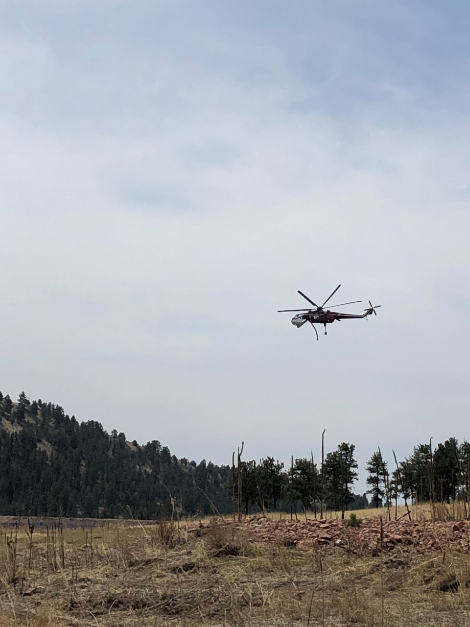 Helicopter is flying over the Fourmile Station heading to Wrights Reservoir to pull water.
