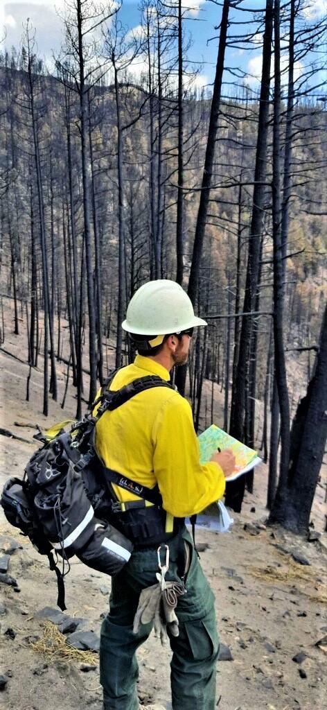 Photo showing BAER Specialist Micah Kiesow Assessing Soil Burn Severity in Gallinas Watershed within Hermits Peak Burned Area