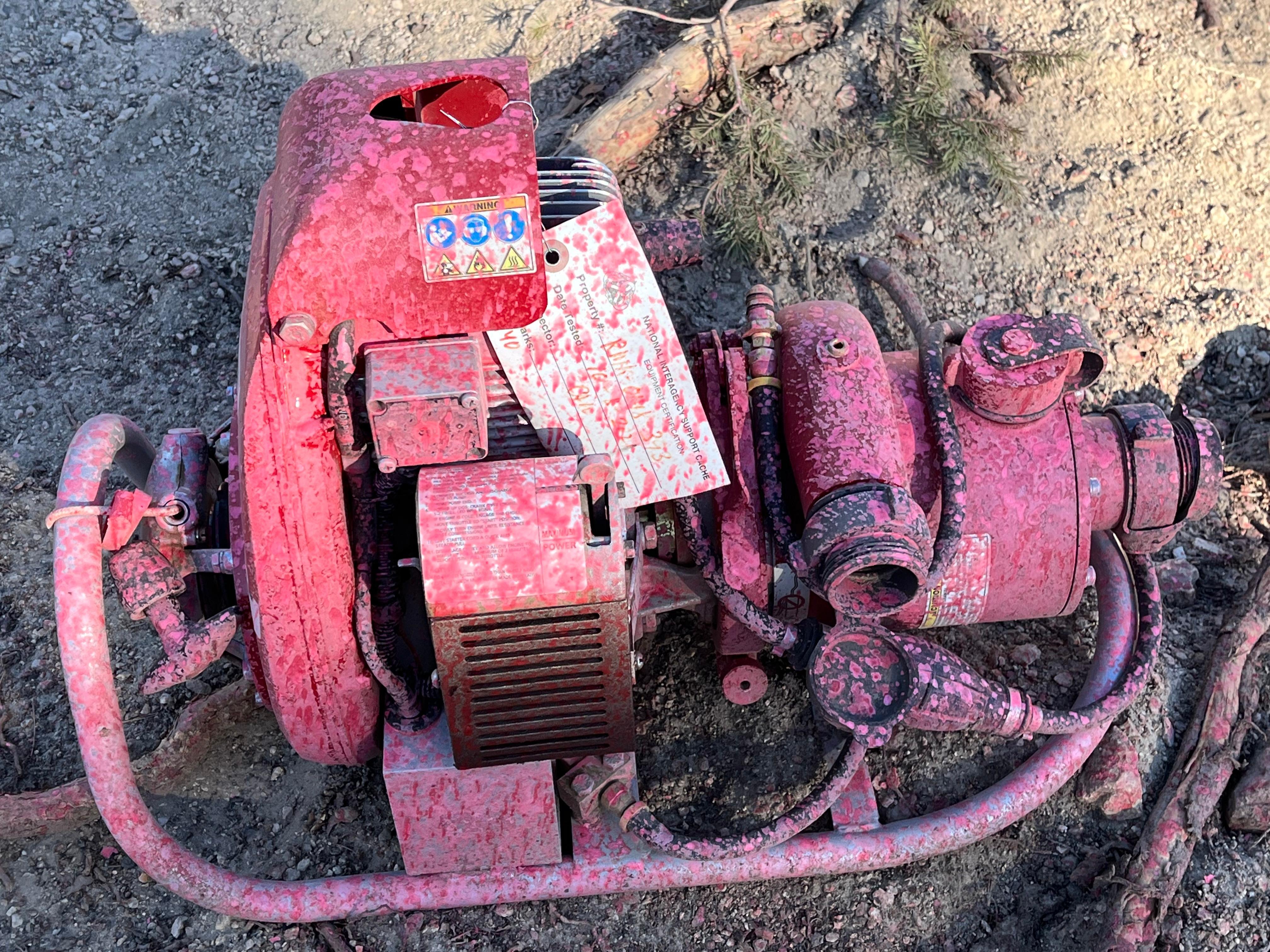 a red pump is covered in pink retardant