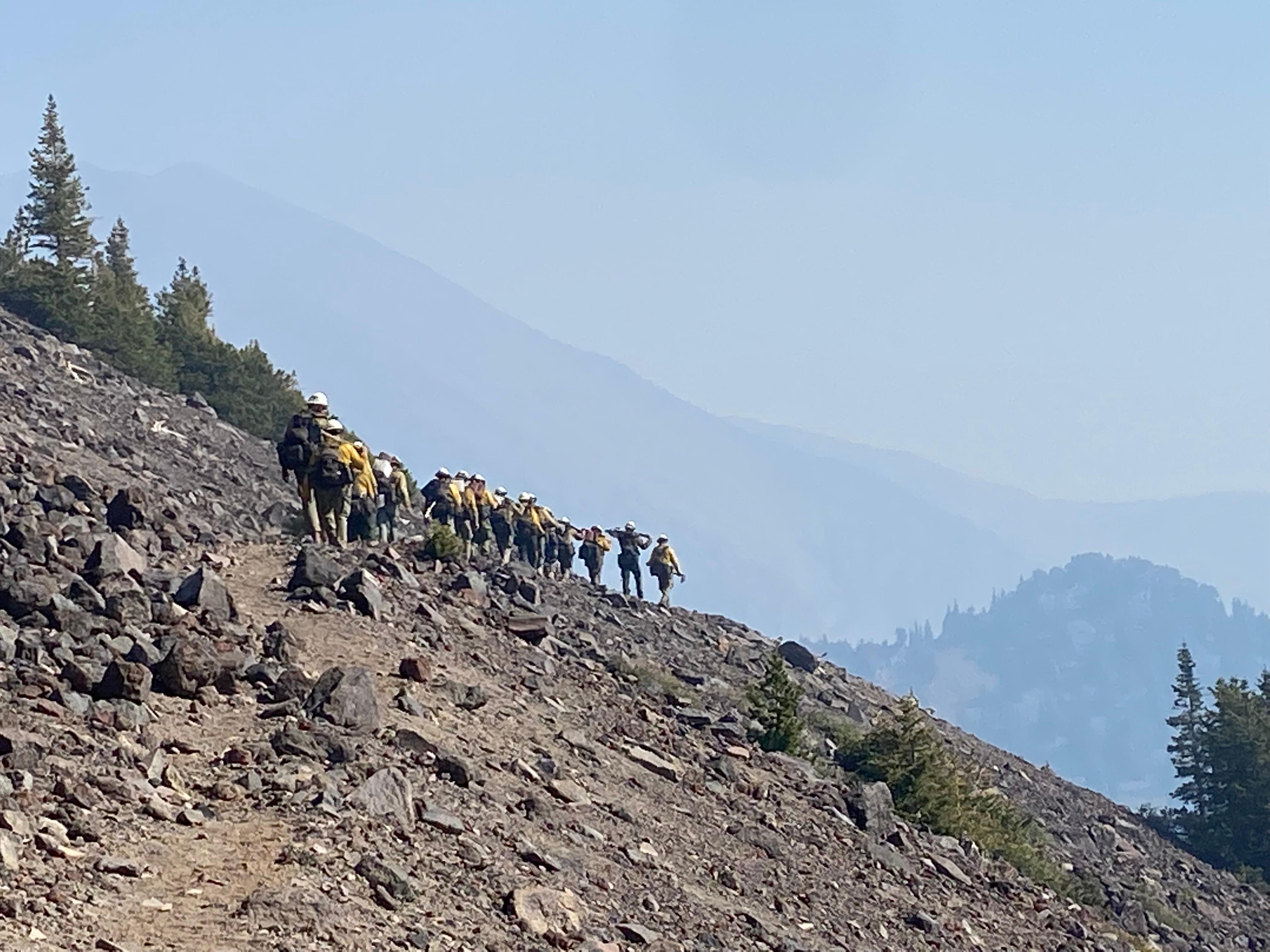 Flagstaff Hotshots walk from the Arizona Snowbowl to Fremeont Peak to dig fireline to stop the western spread of the Pipeline Fire June 15, 2022. photo by Mark Adams