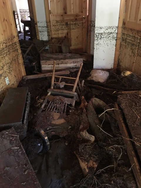Jumbled, dirty furniture inside a cabin