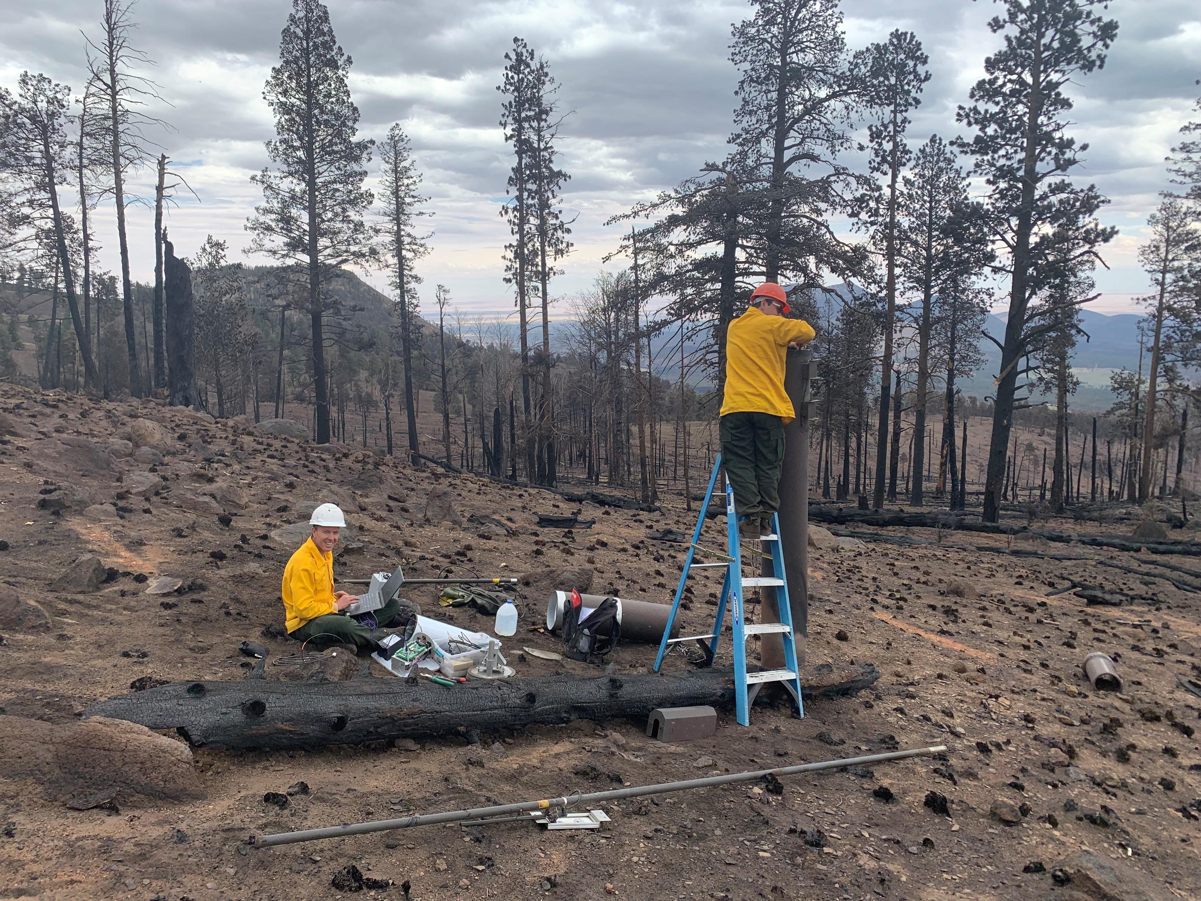 Technicians from JE Fuller Engineering and Geomorphology repair a flood warning rain gauge that was damaged by the Pipeline Fire along the Waterline Road on June 22.  Photo Kelly Mott Lacroix USFS