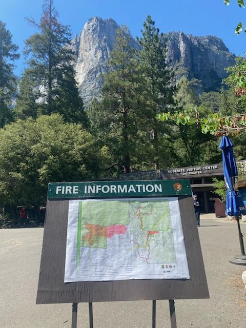 Photo shows an information station with a Map of the Washburn Fire. Trees and Rocks are in the background