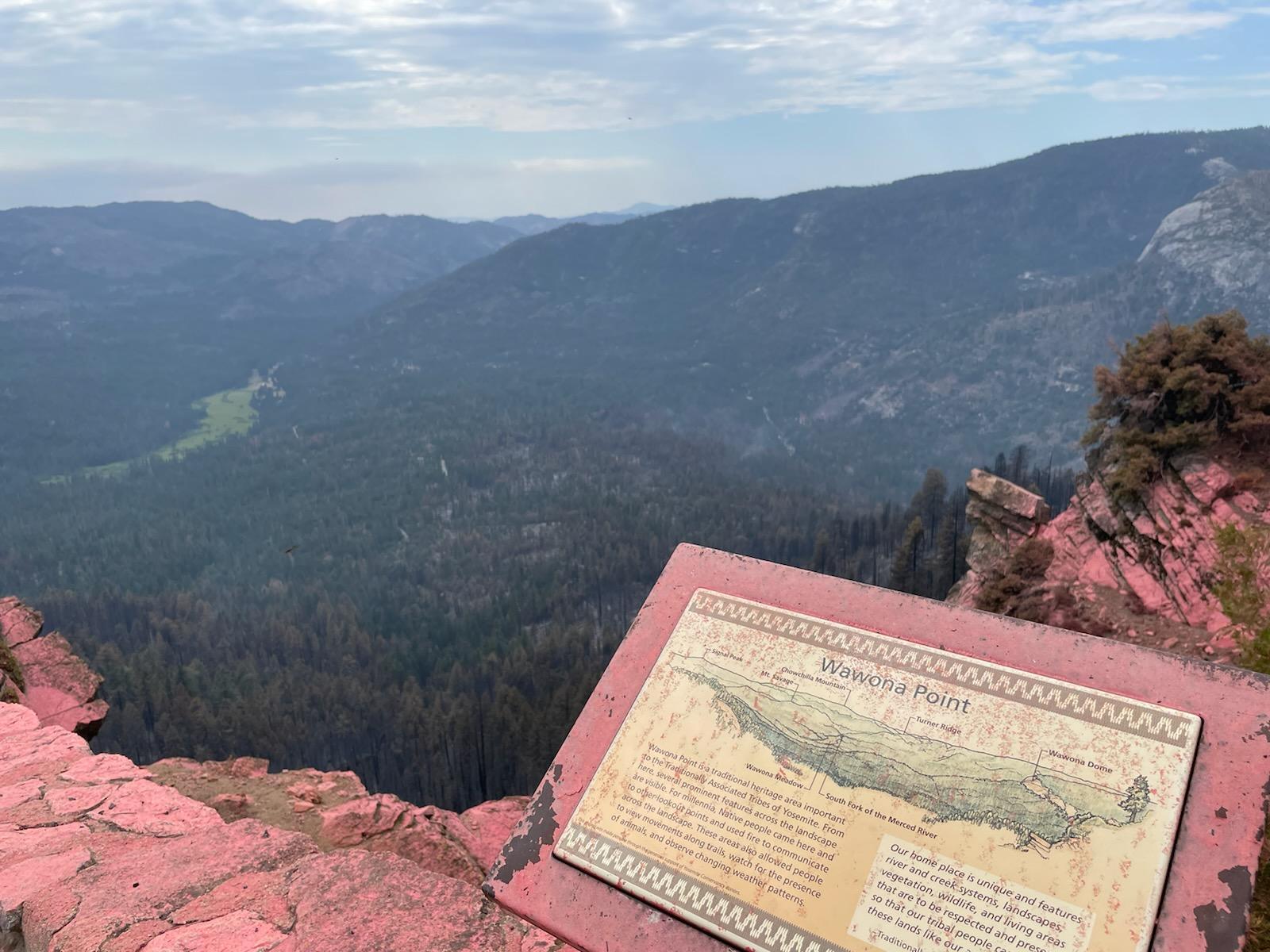 This image shows an interpretive sign located at Wawona Point which has been covered in pink from ffire retardant used to slow the spread of the fire