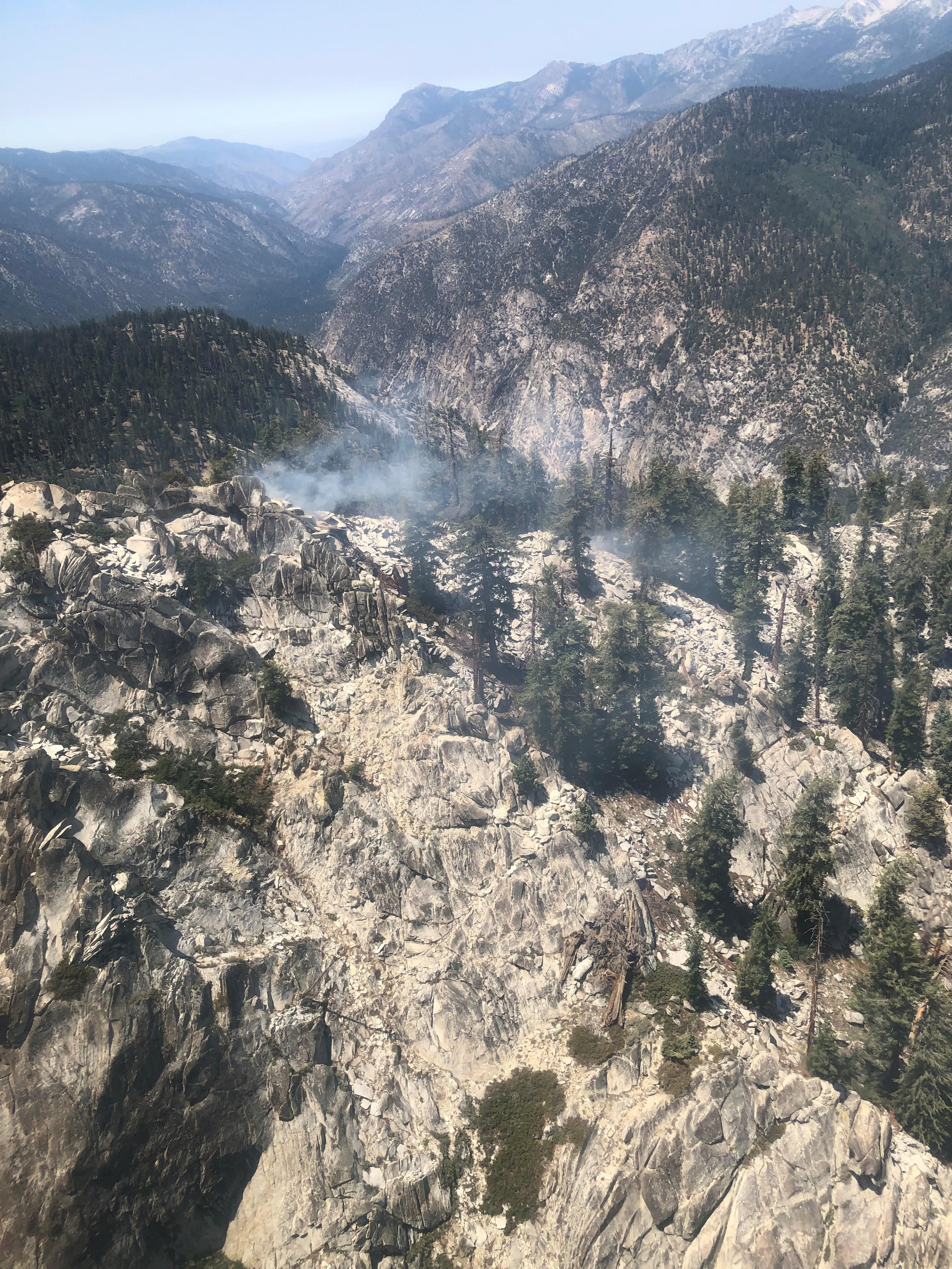 One prominent smoke along the eastern ridge where the fire is burning in a heavy downed log. There are some broken fuels on the east side of the ridge.