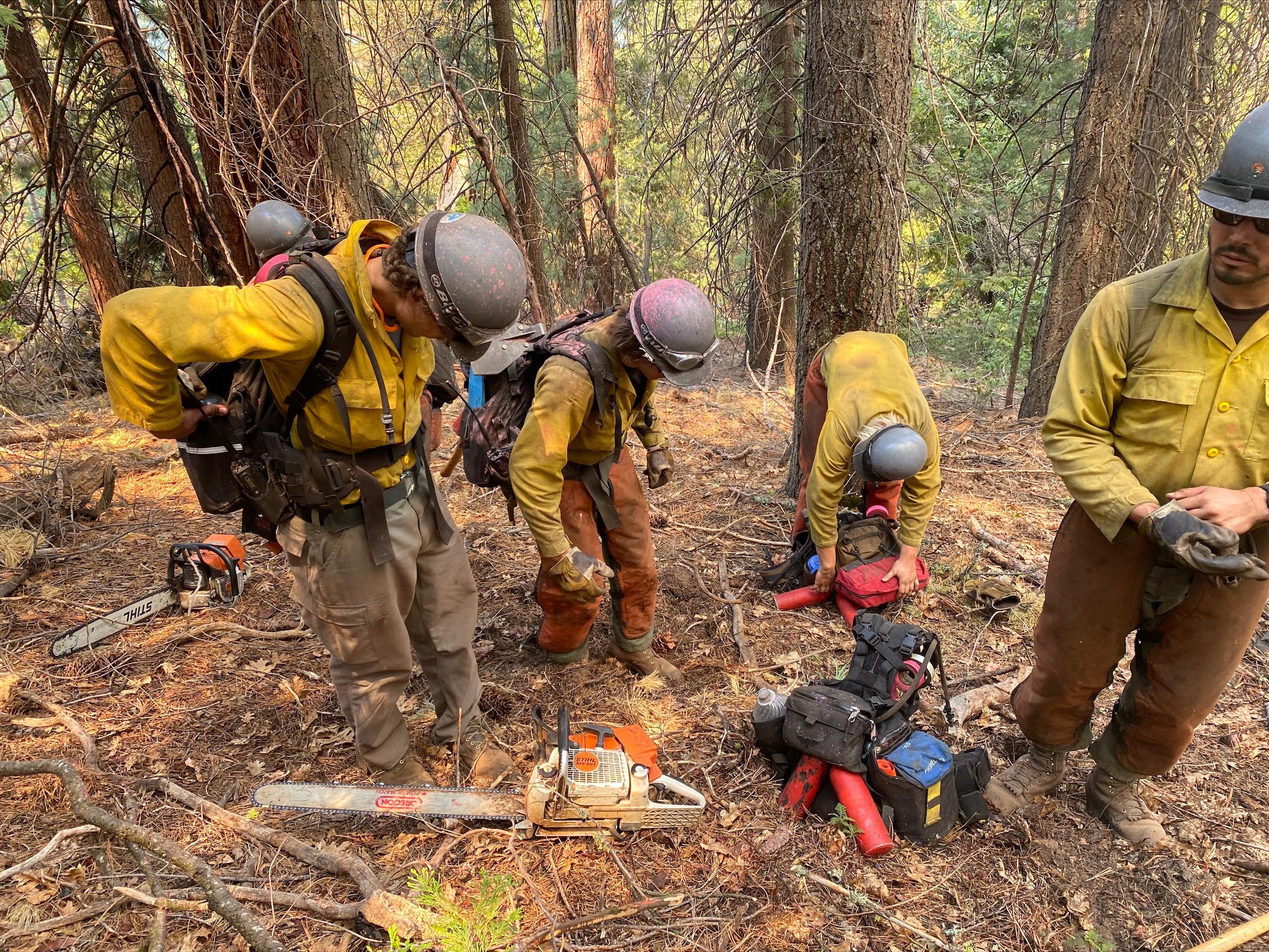 Saw teams on Yosemite National Parks Wildland Fire Module Crew 1 work quickly to refuel and rehab their tools while on the fire line.