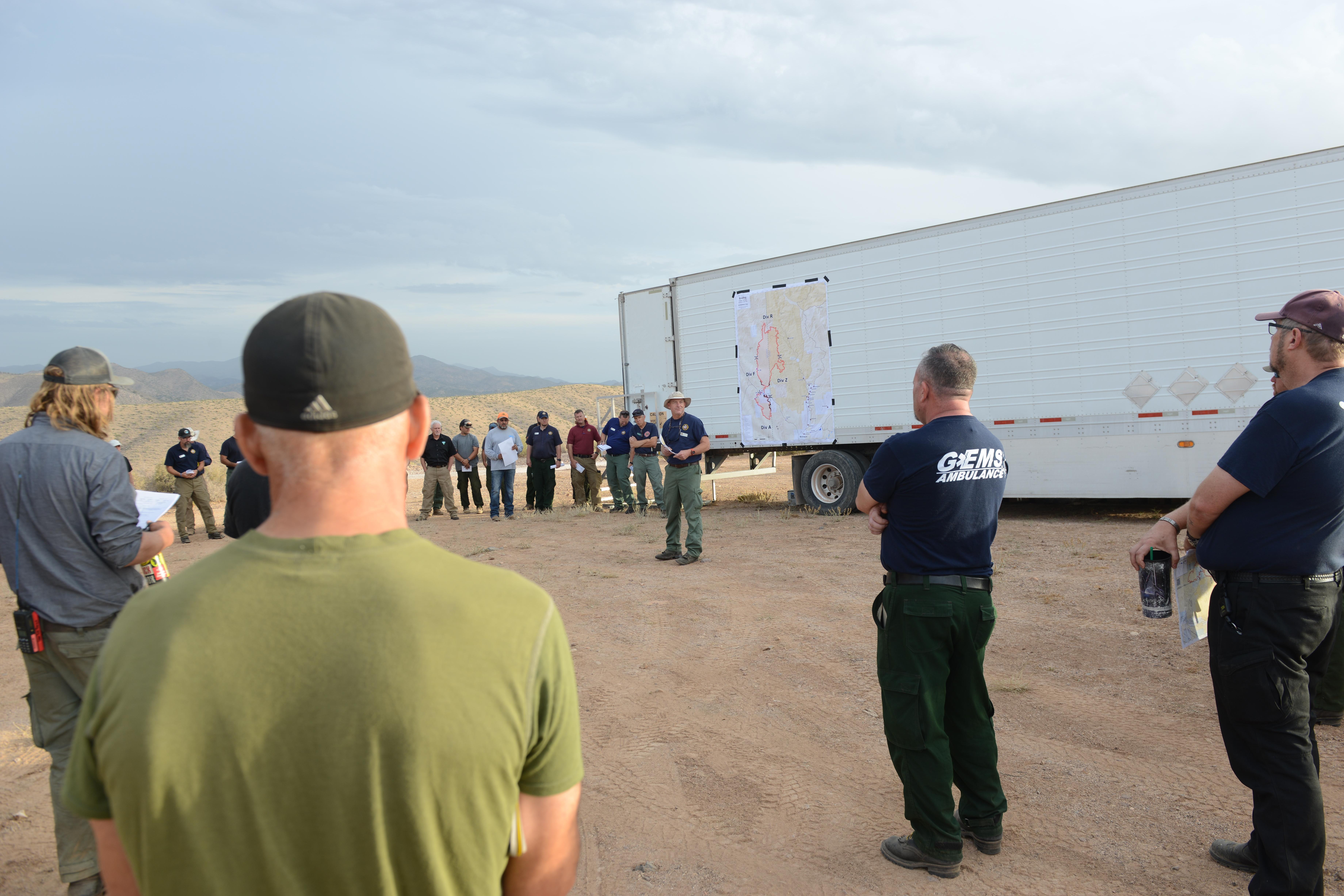 Wildland firefighters listen to the Dodge Creek Fire morning operations briefing July 25, 2022.