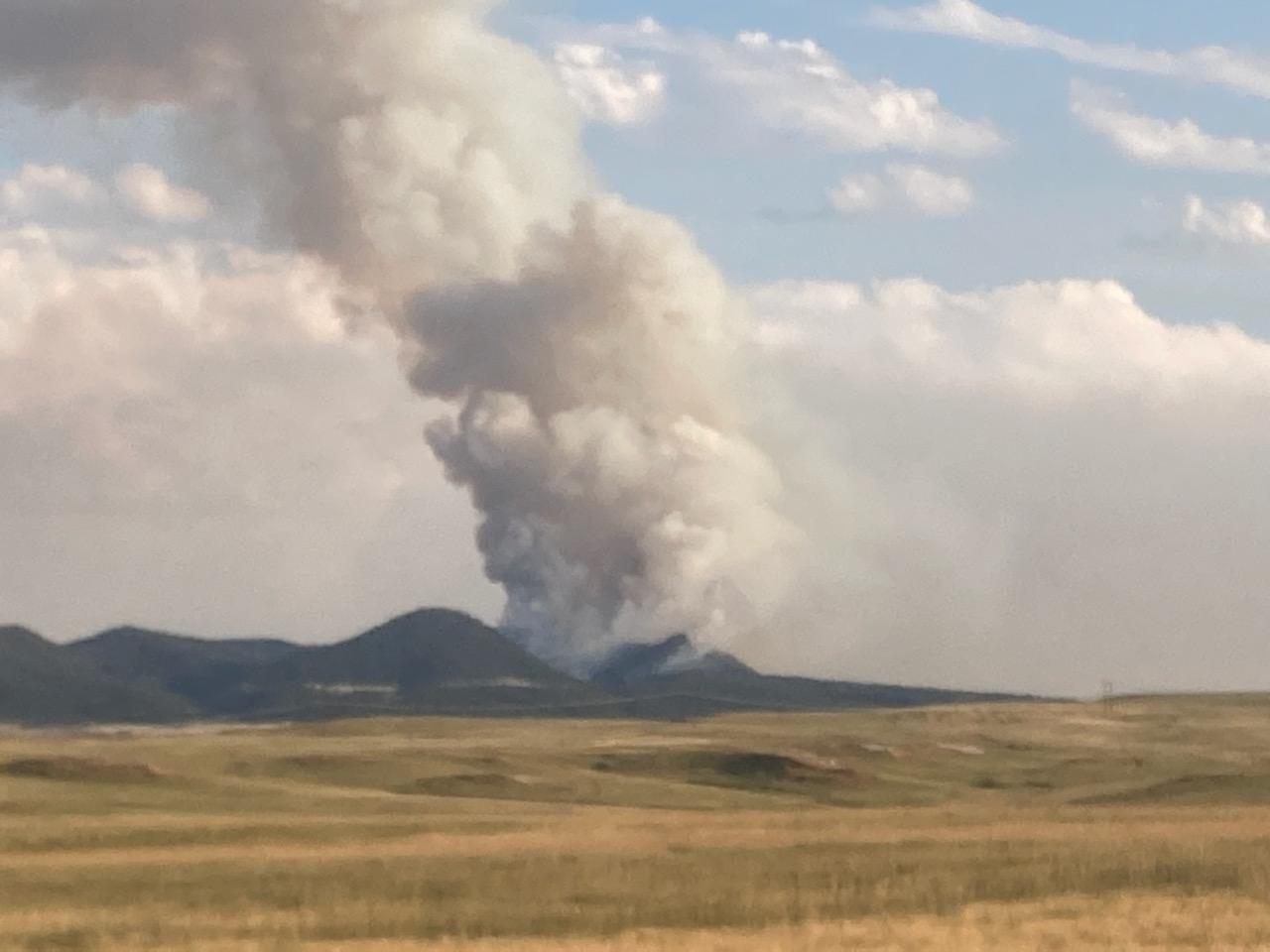smoke rises from the Fish Fire on Sunday,  July 31