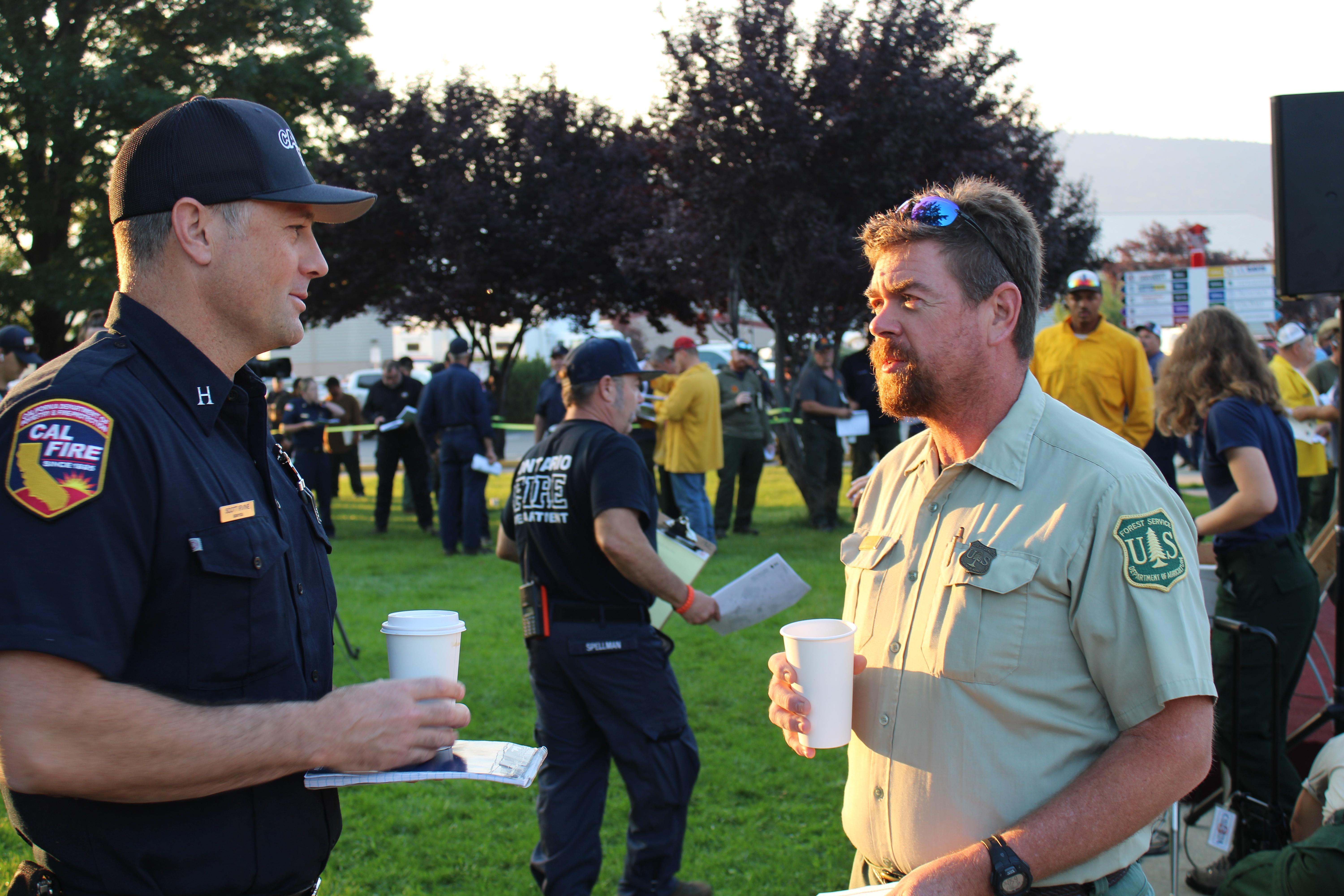 Fire Managers discuss the day over a cup of coffee before the morning briefing held on August 3, 2022