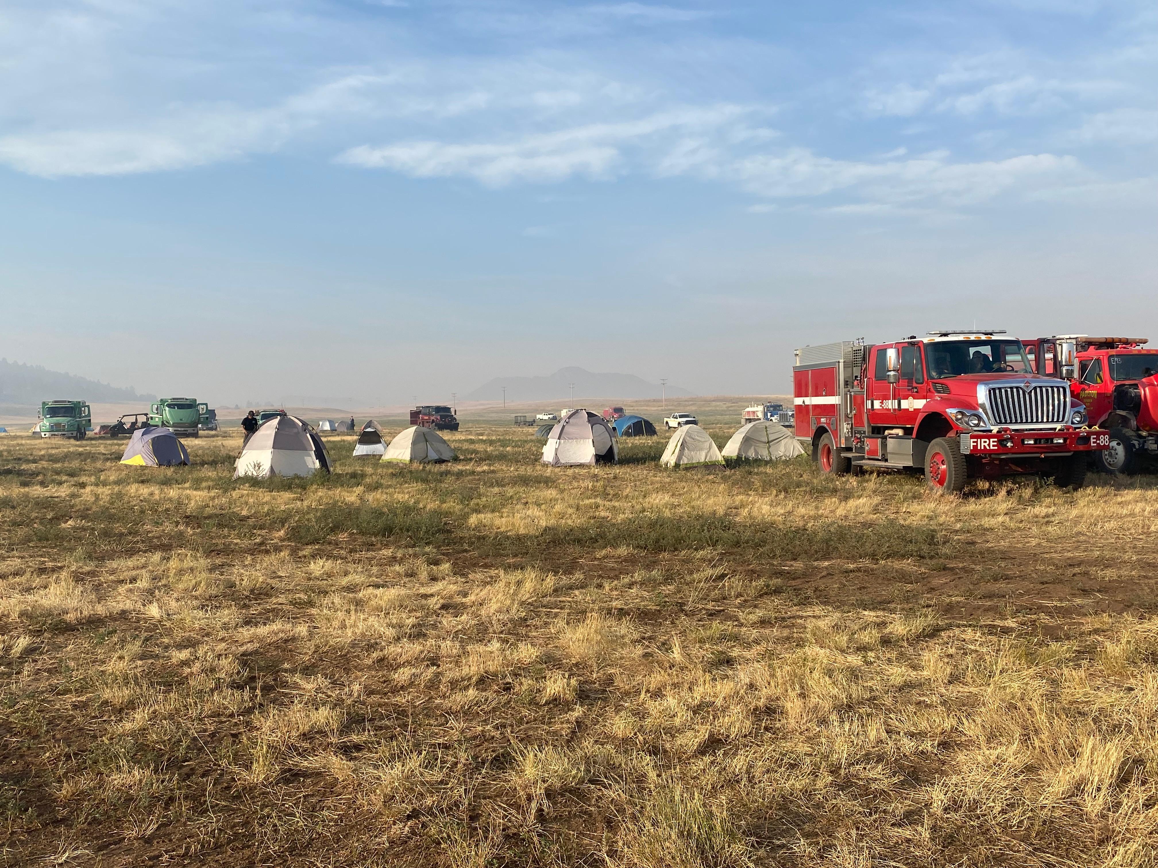Engines and firefighter tents at forward operation base
