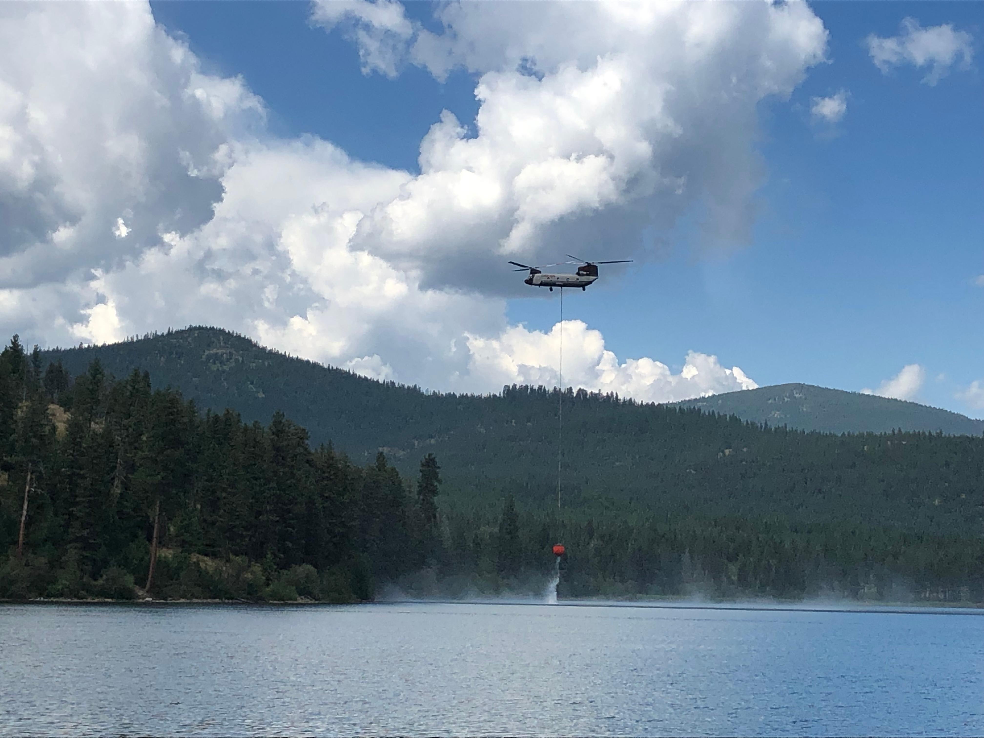 Type 1 Helicopter lifts bucket drops out of Lake Mary Ronan delivering to northern portion of Elmo Fire
