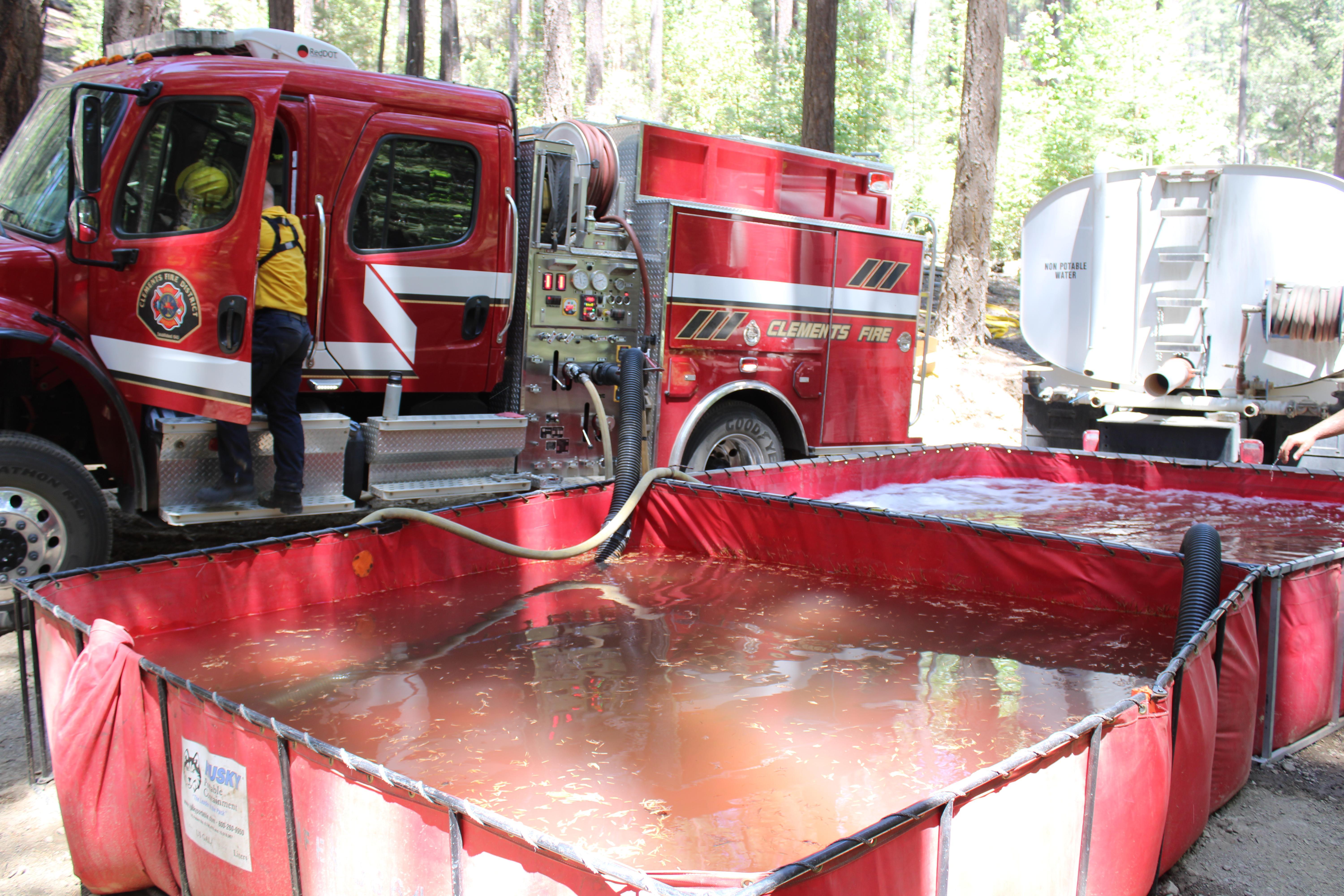 Clements Fire supplying hose line from two portable water tanks