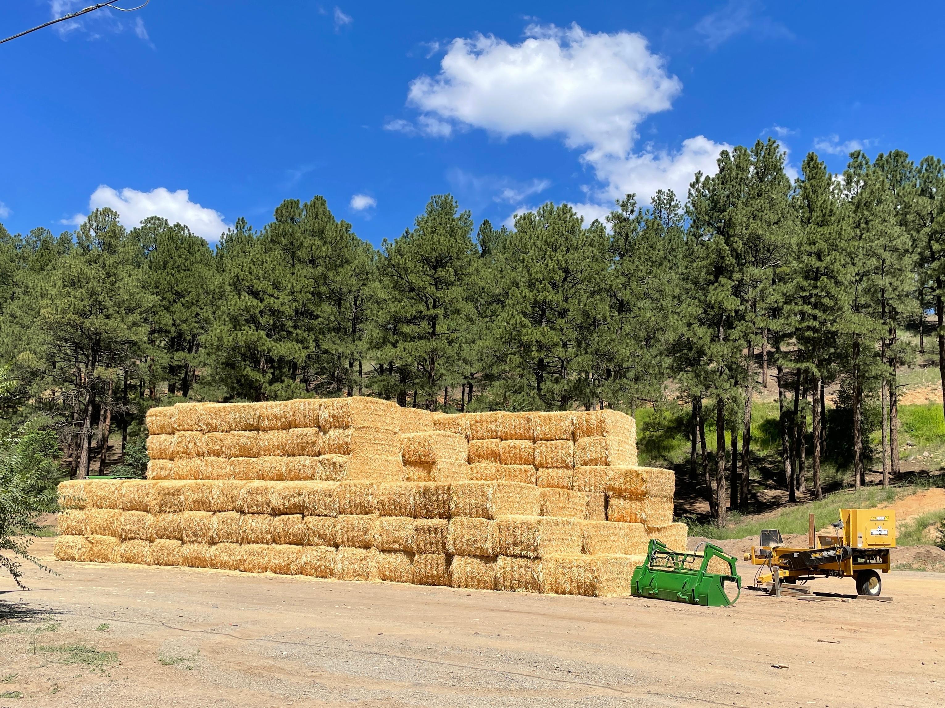 Image of straw stacked in a staging area near the Skating Pond.