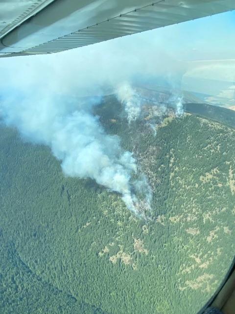 Aerial observation is conducted to assess fire behavior