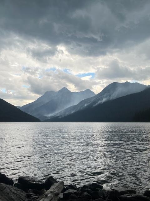 Quartz Lake with smoke rising from the forested slopes beyond.