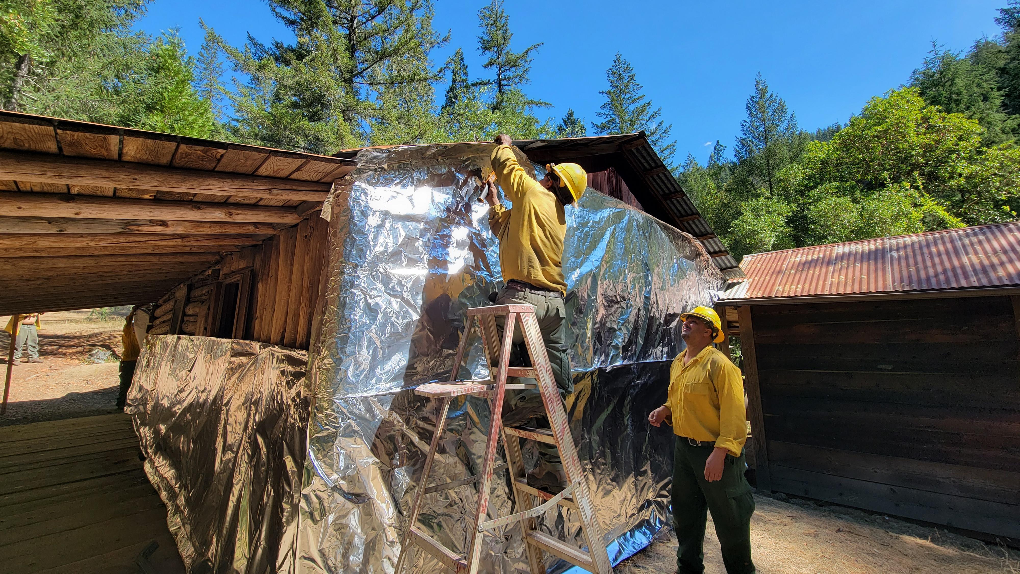 Historical Whiskey Creek Cabin during structure wrapping