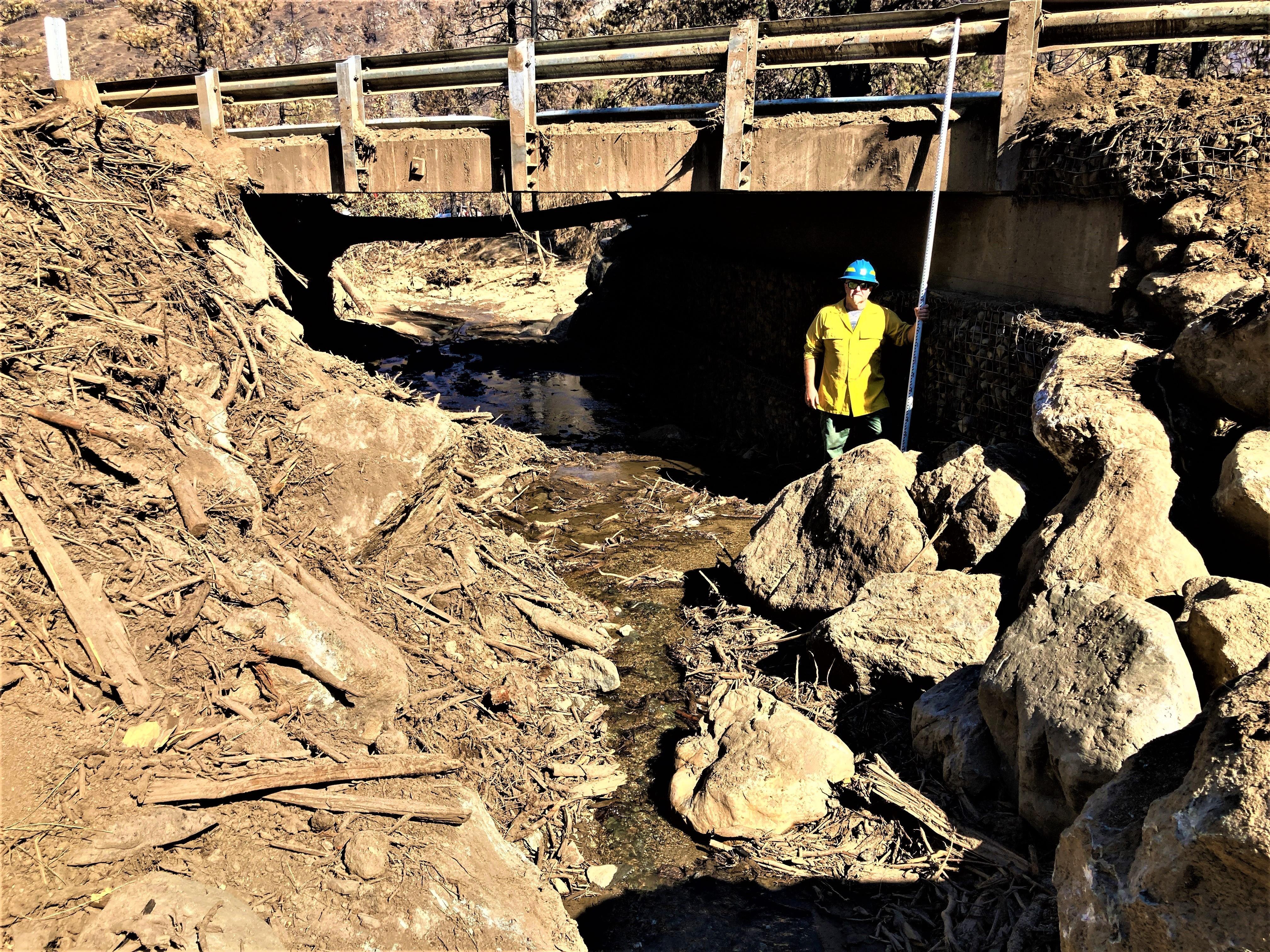 Image showing BAER Geologists assessing impacts from 8-2-22 debris flow event at a bridge just above the confluence of Little Humbug Creek and the Klamath River 