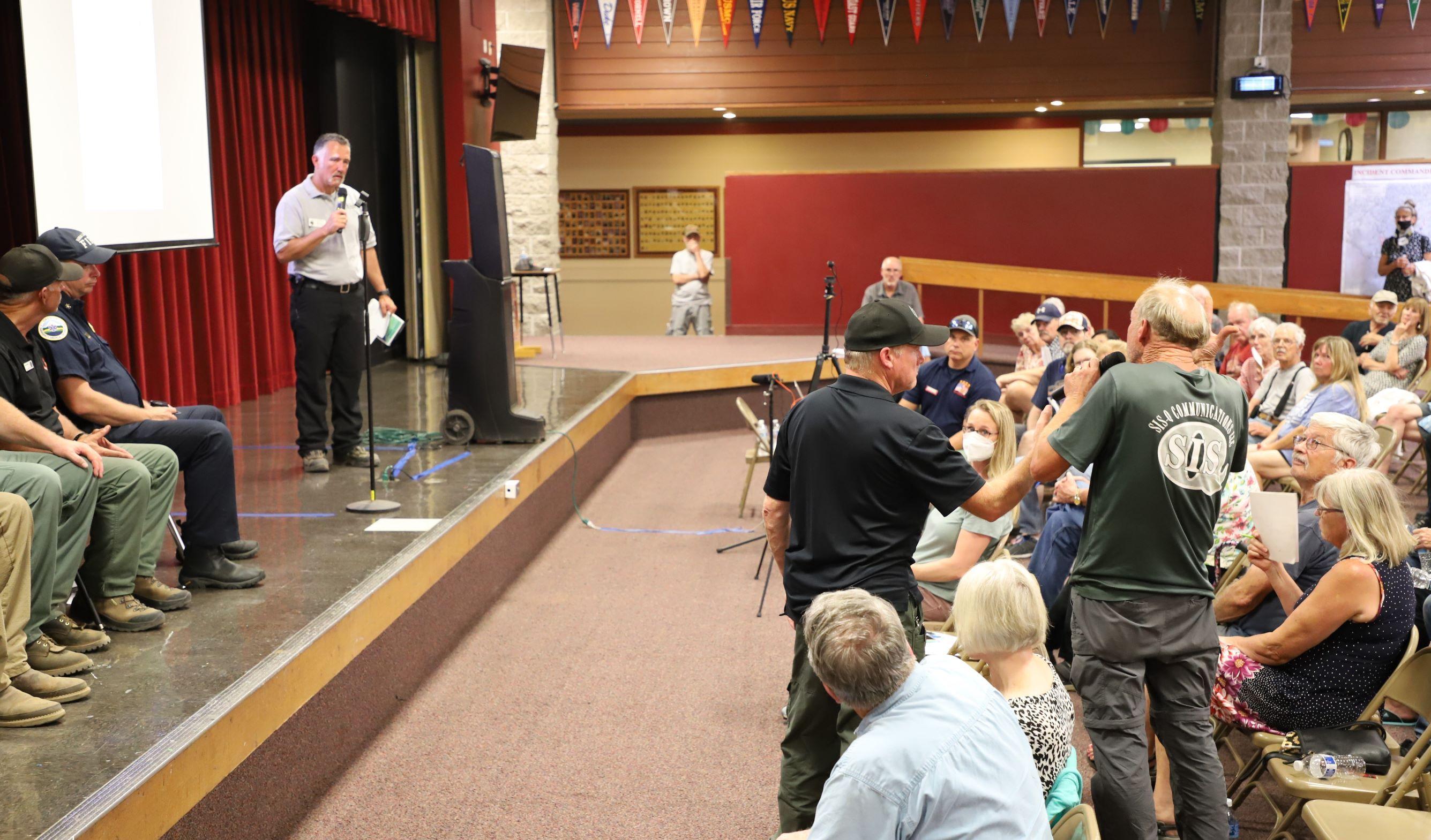 A member of the audience is asking a fire representative a question during the community meeting held August 30 in Grants Pass.