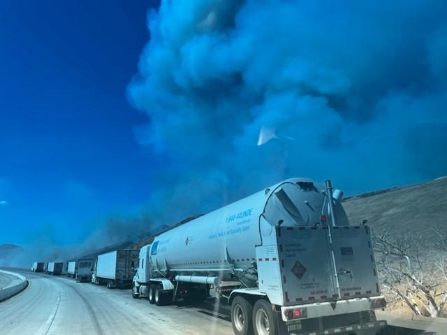 Semi-trucks pulled over off of road due to fire