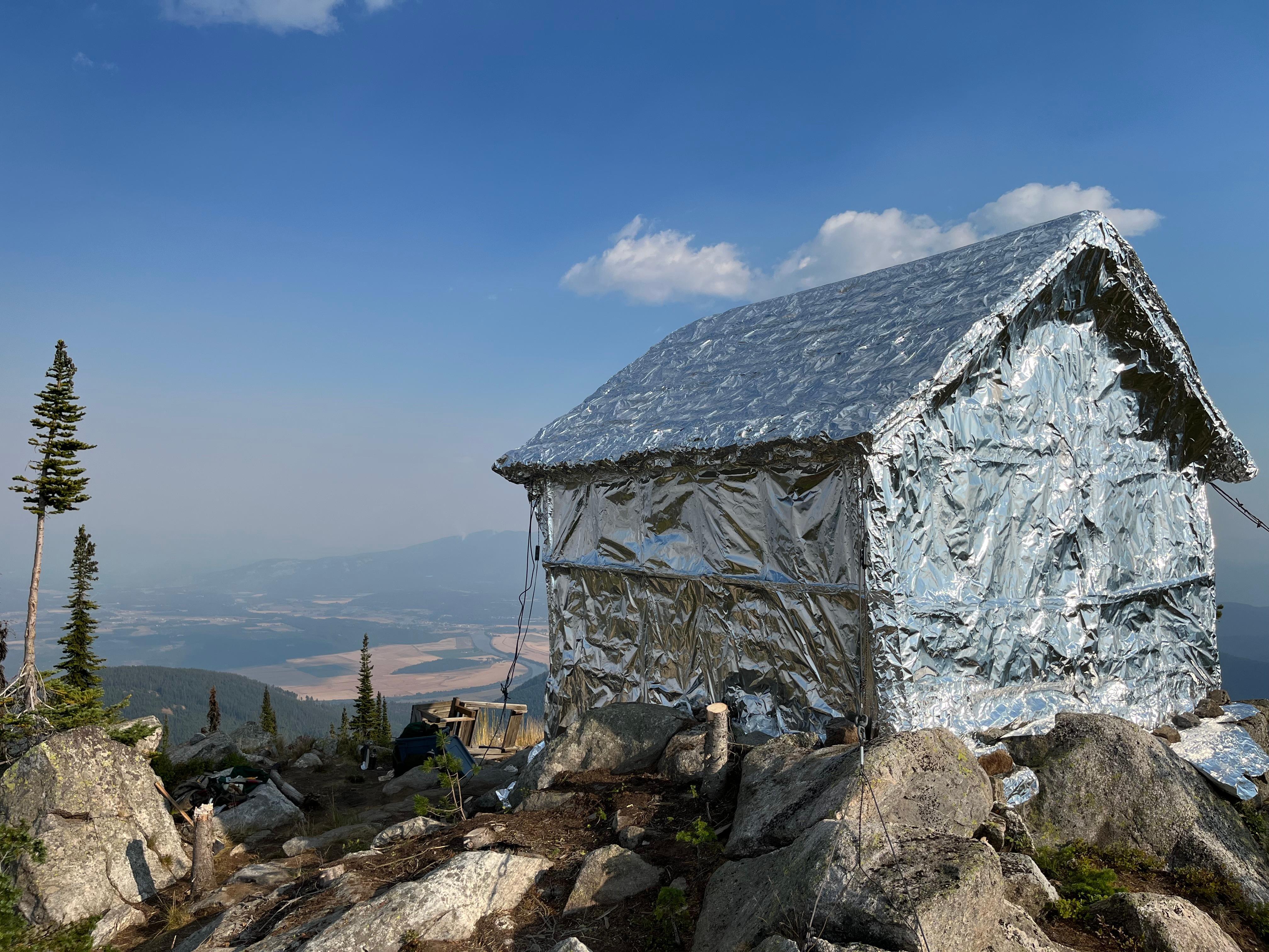 Burton Peak Lookout post wrapping. Wrap protects structure from radiant and convective heat and burning embers.