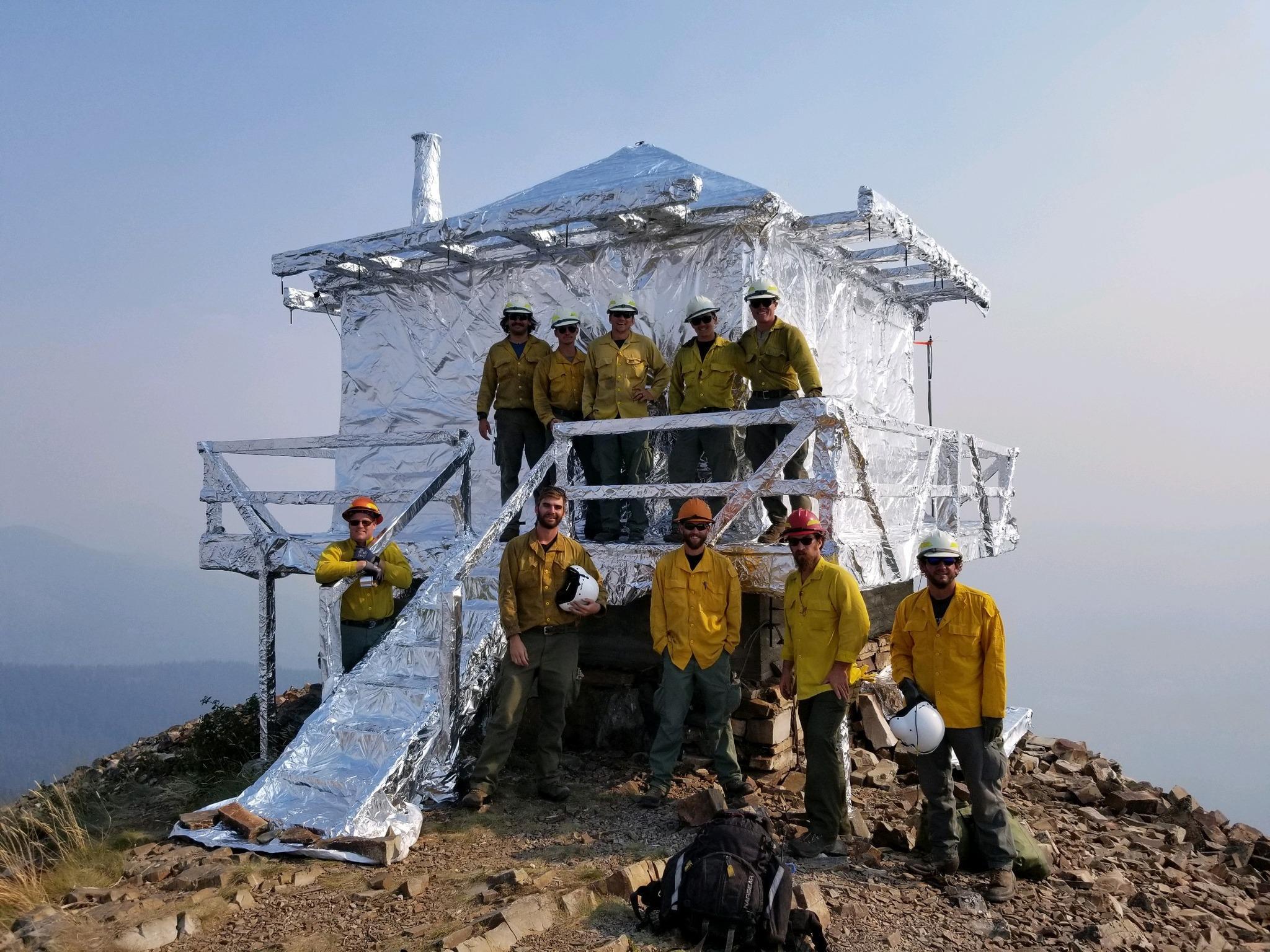 Local Cabinet Ranger District employees and Grangeville Helitack crew members flew to the Star Peak Lookout yesterday and successfully wrapped the lookout in heat resistant material.