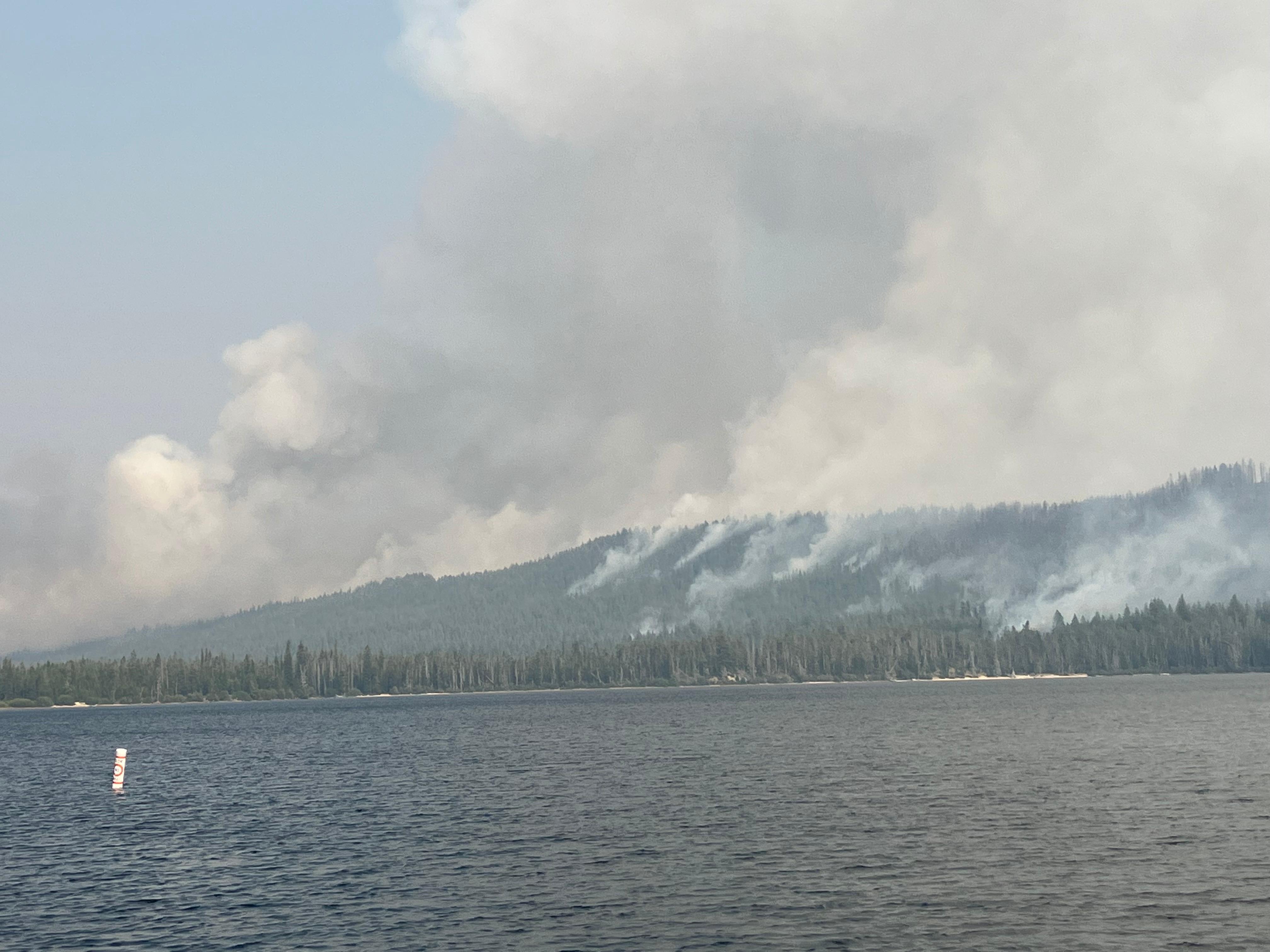 Smoke rising from slopes along Alturas Lake