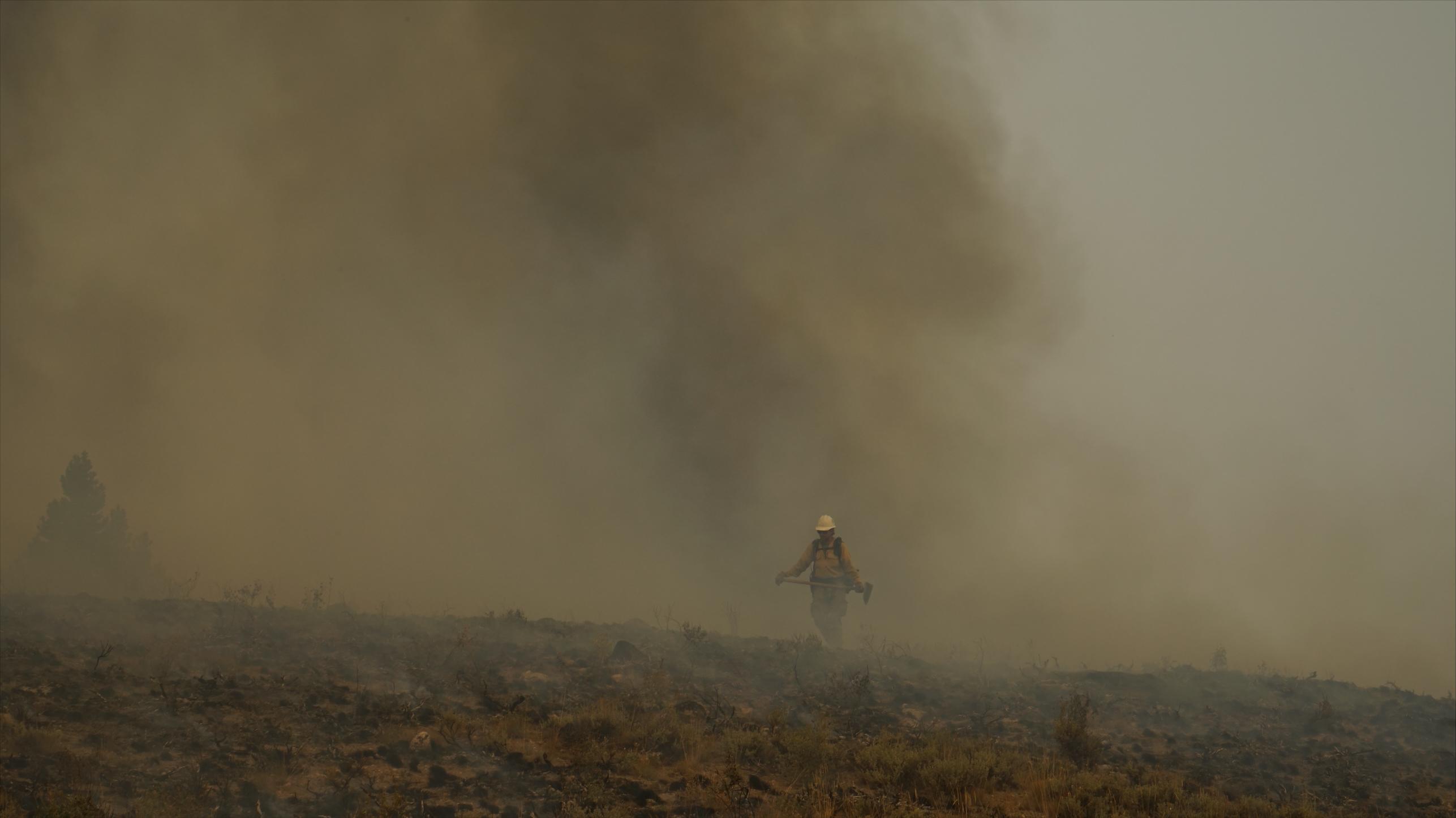Firefighter walking in smoky conditions
