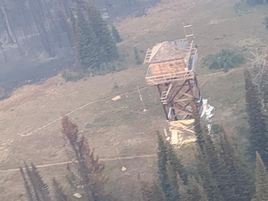 Hazy photo of a Fire Lookout and other structures on a wilderness ridge top